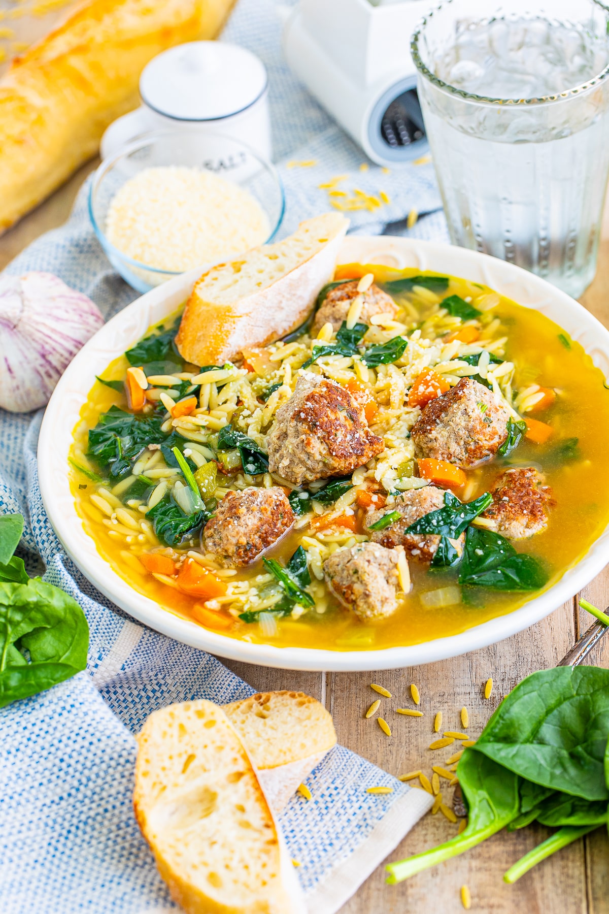 the best italian wedding soup recipe in a tan bowl on a wood table top