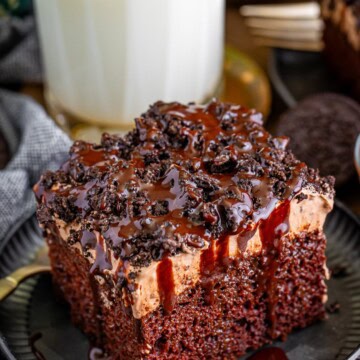 A slice of Oreo better than sex cake with chocolate whipped topping and Oreo crumbles