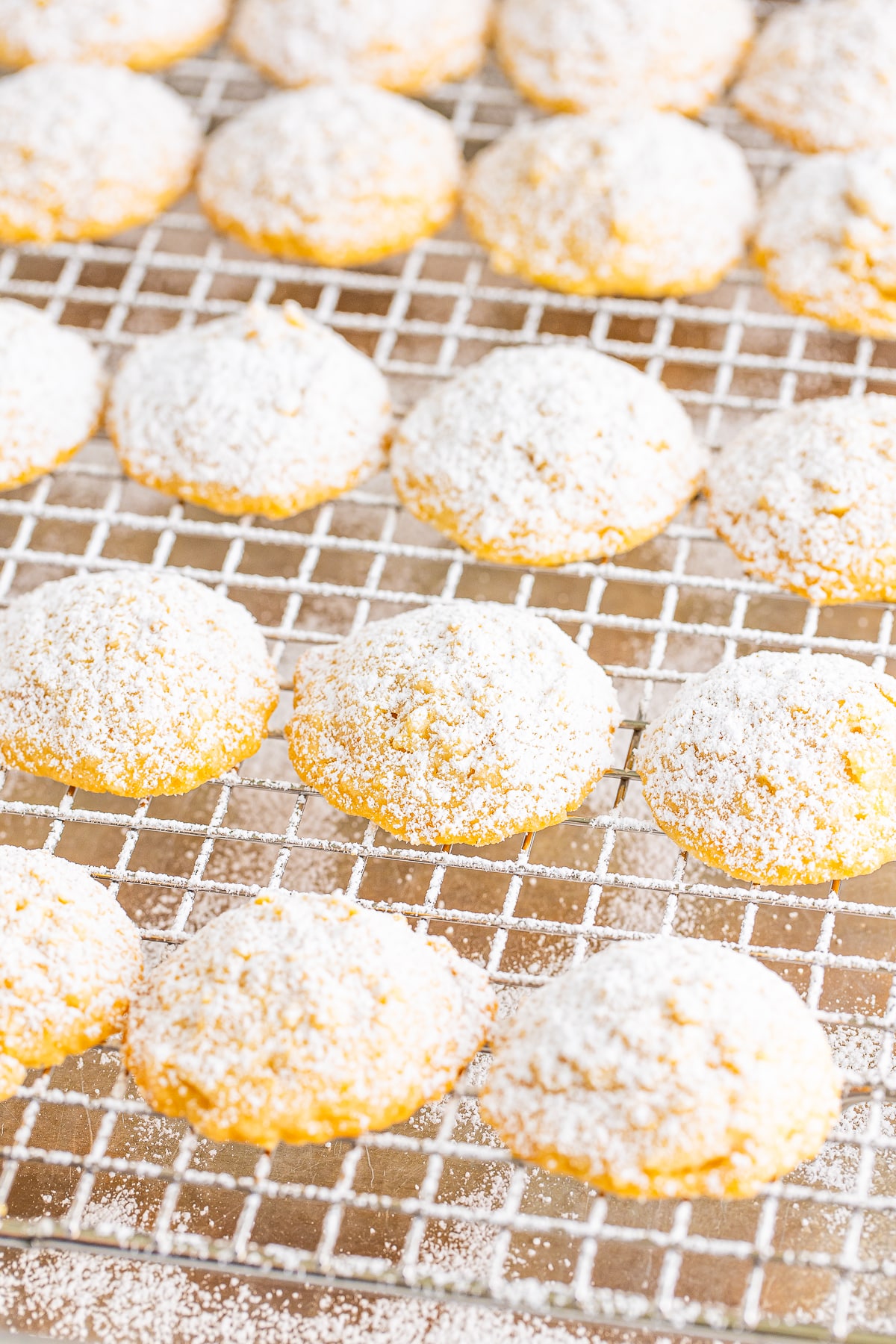 potato chip cookies covered in powdered sugar on a wire rack