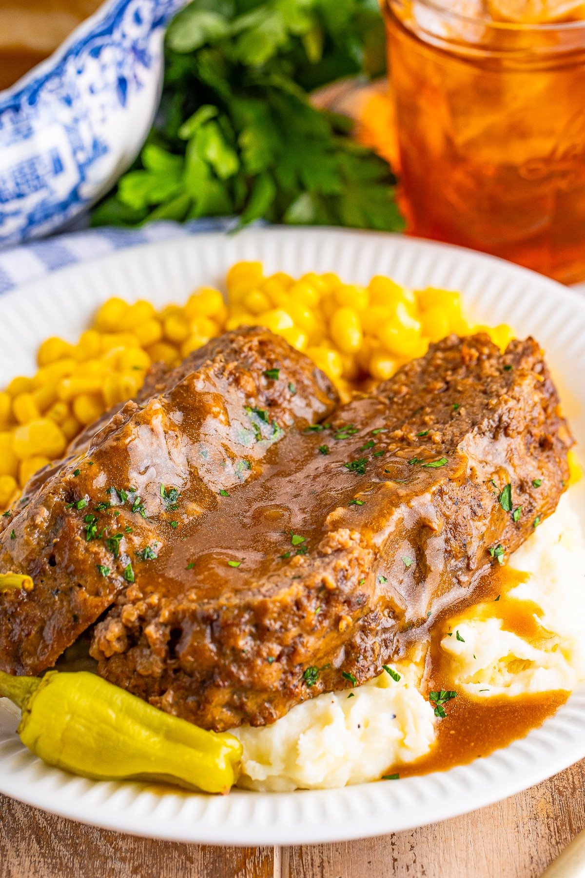 crock pot meatloaf on a white plate with gravy