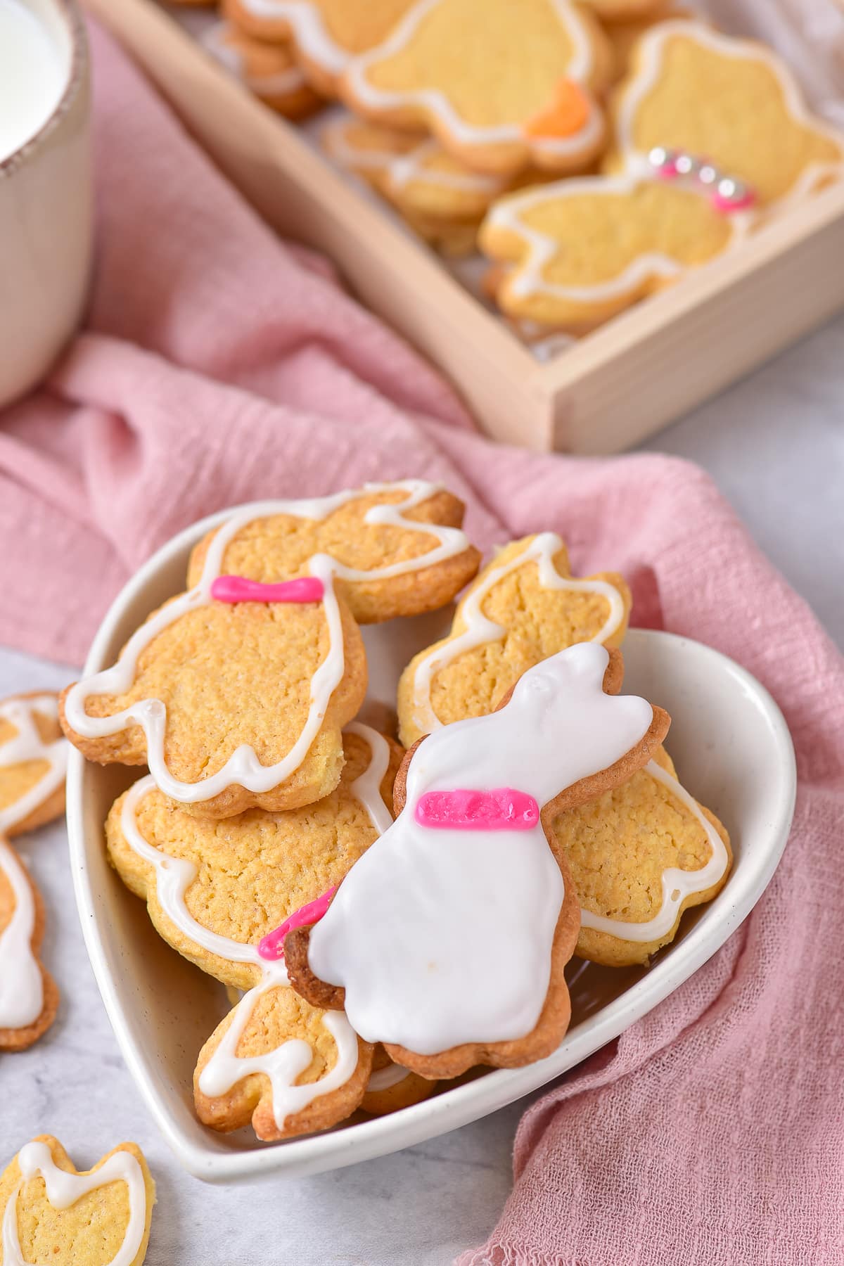 decorated bunny cookies in a heart shaped bowl