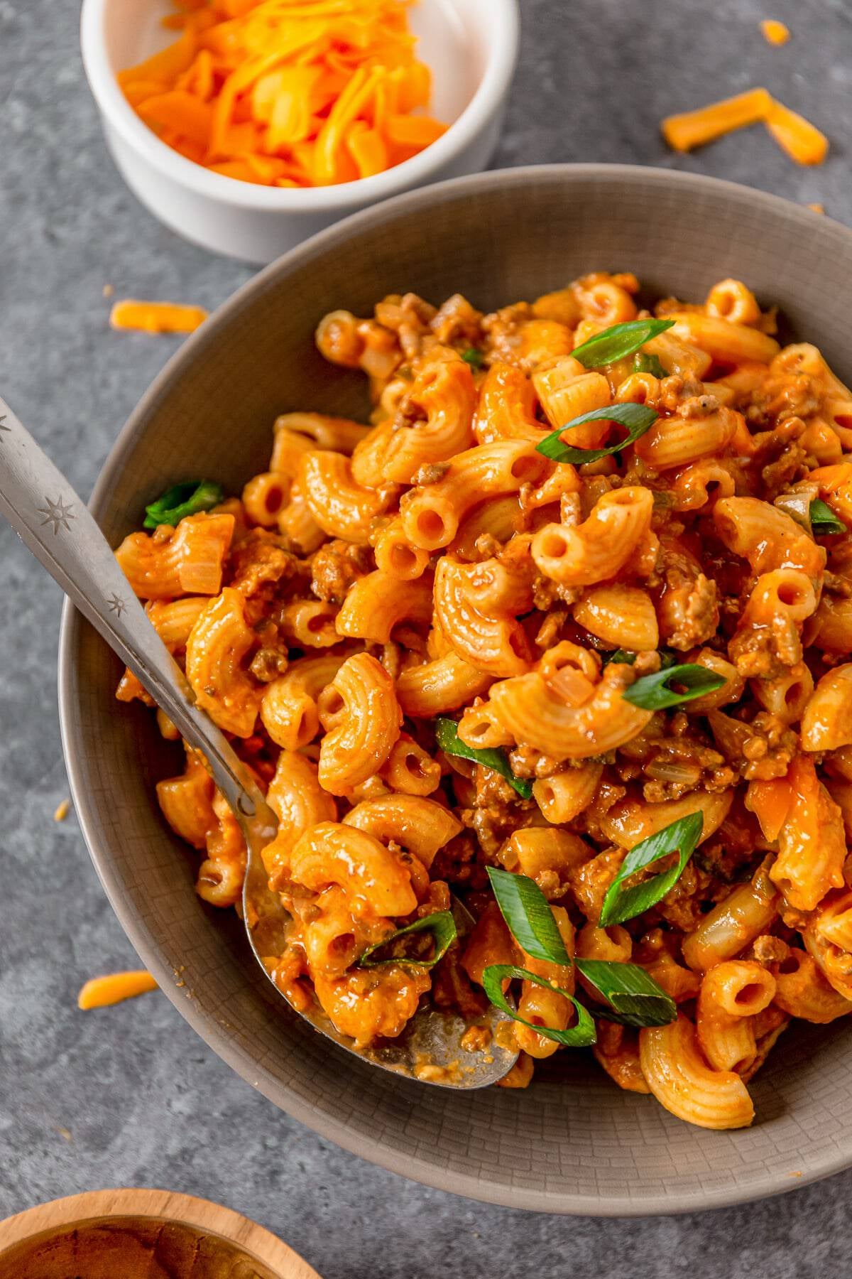 cheeseburger pasta in a grey bowl with spoon