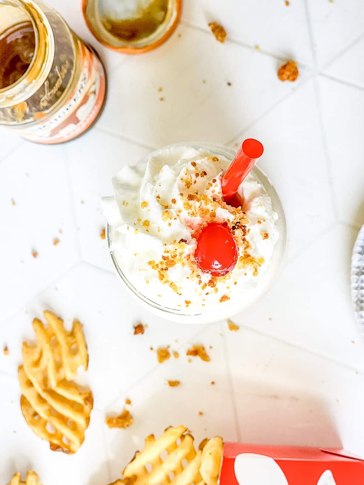 overhead image caramel milkshake on a white table top