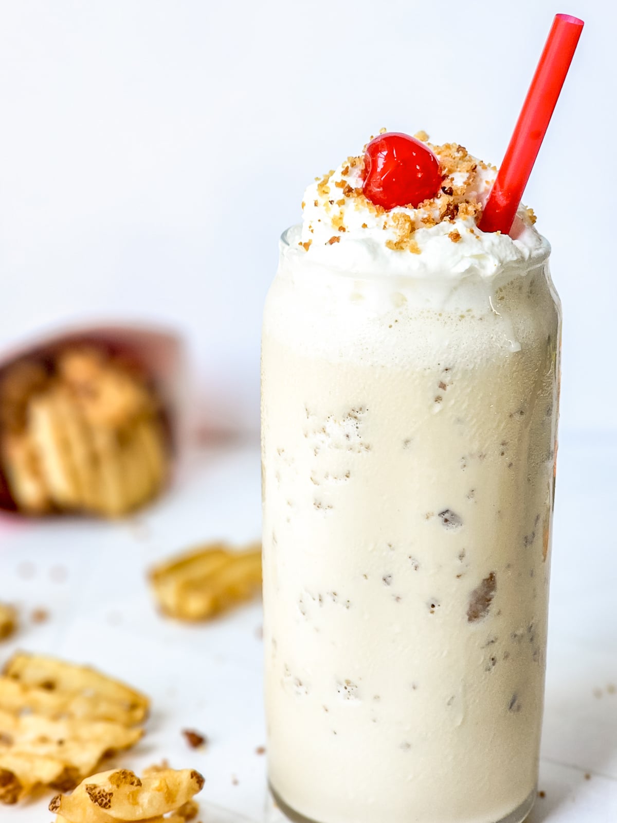 caramel milkshake served in a glass with cherries