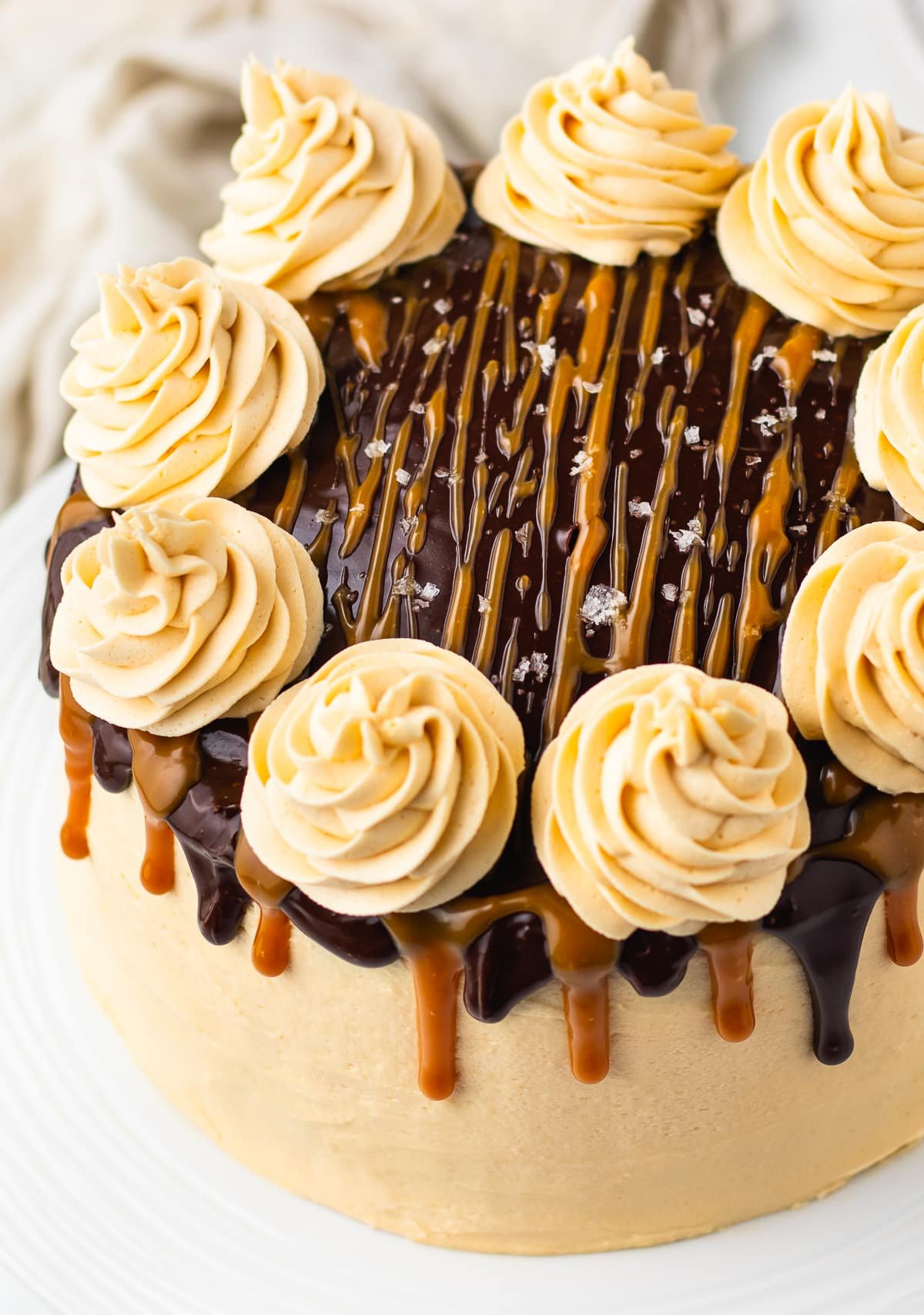 up close image of chocolate caramel cake on a cake stand