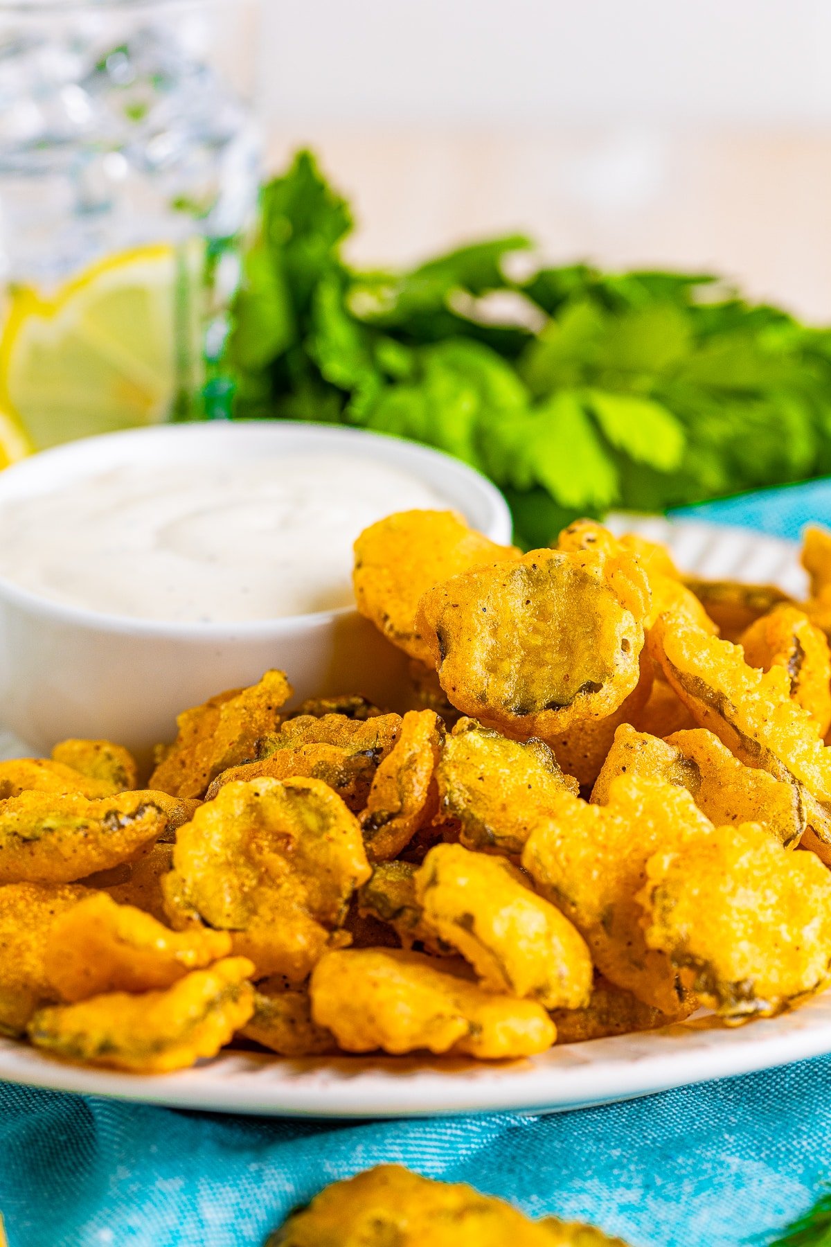 deep fried pickles recipe on a plate with blue linen