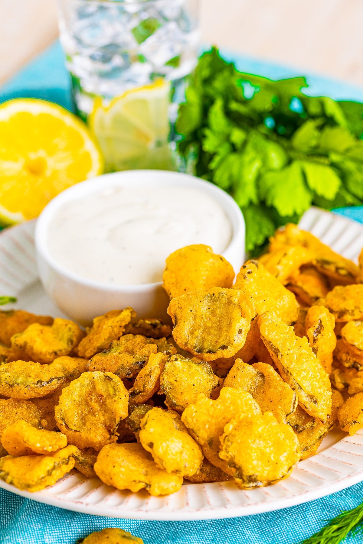 deep fried pickles recipe on a white plate and ranch