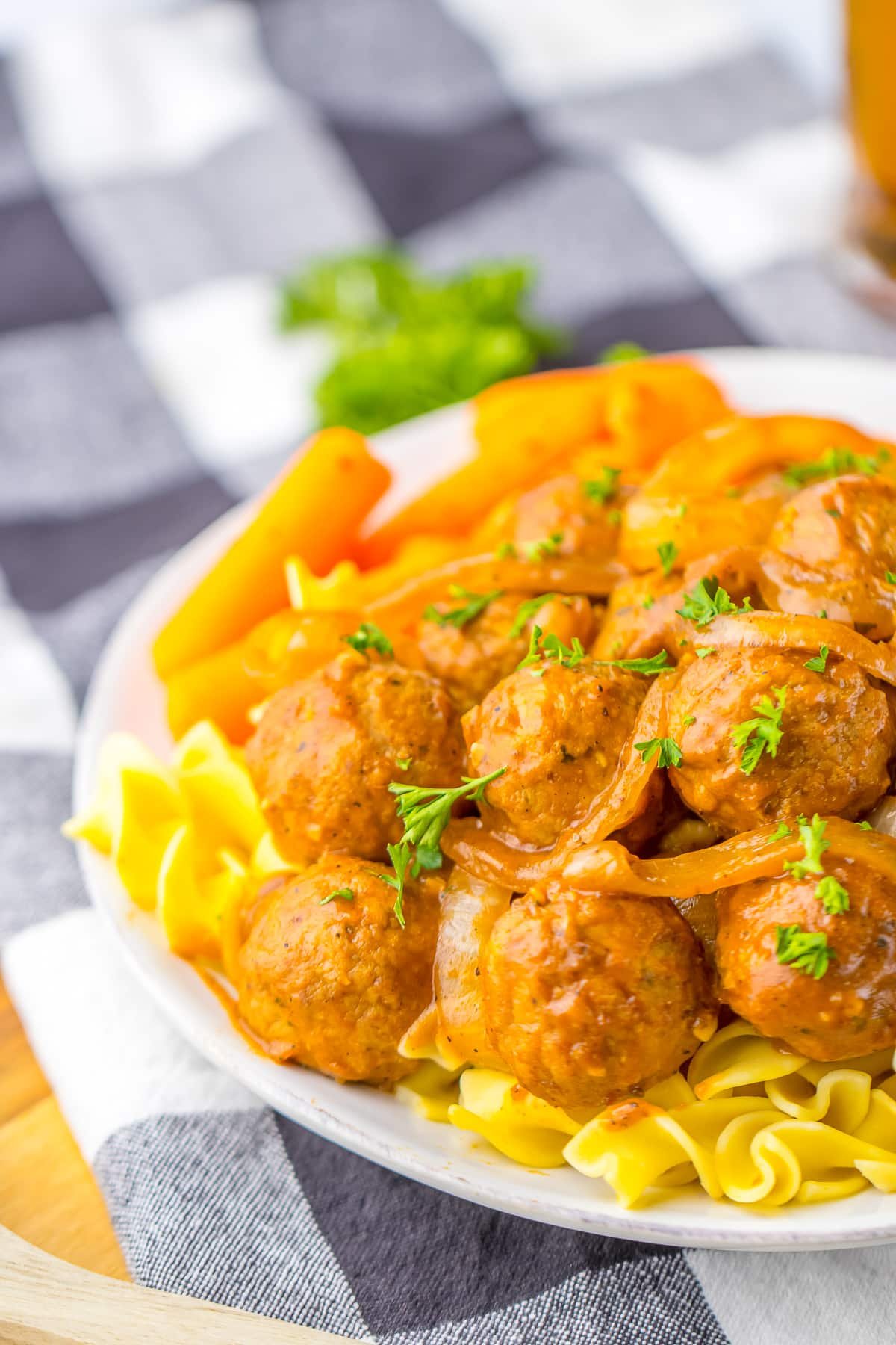 french onion meatballs on white plate with noodles