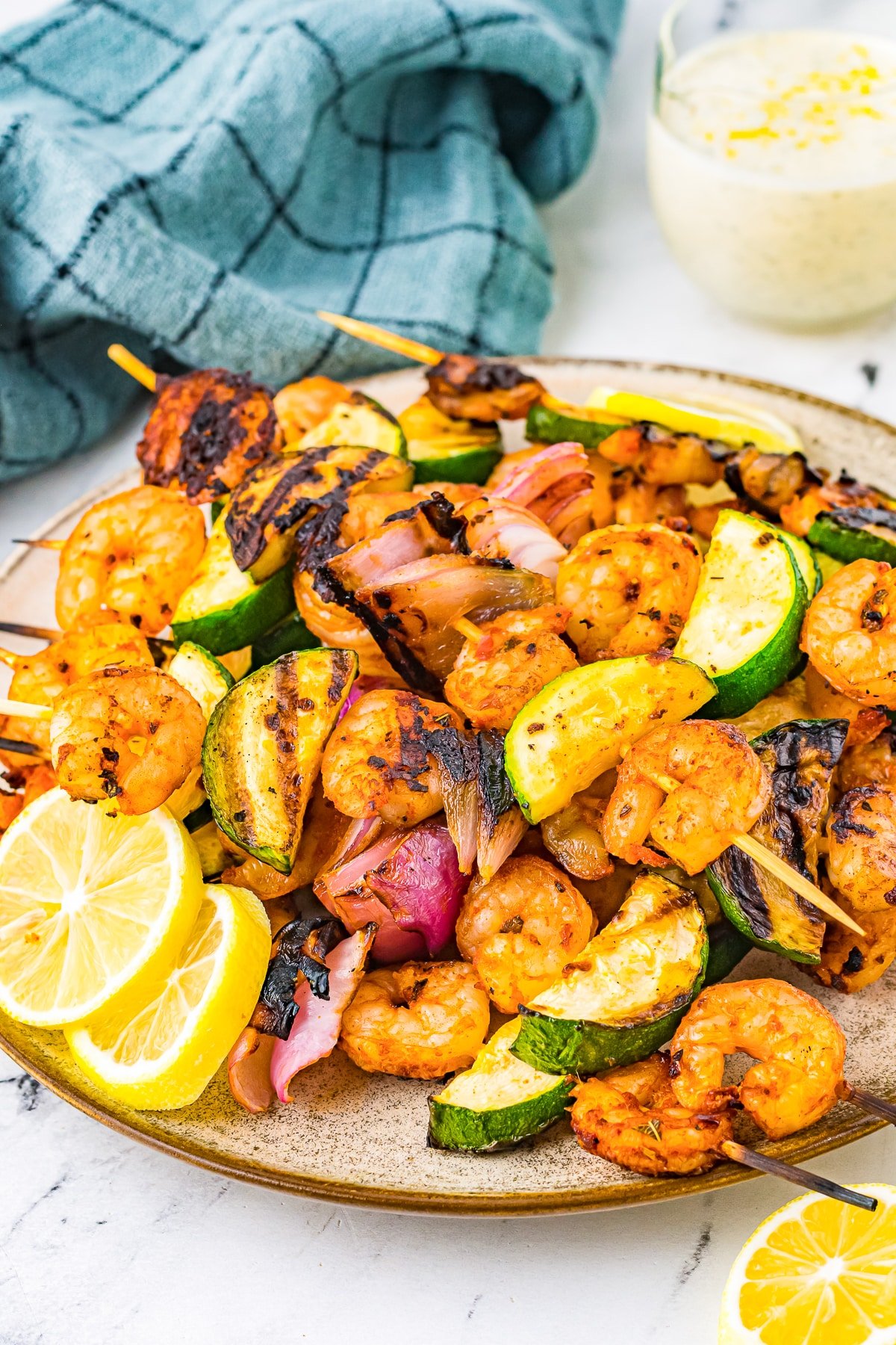 grilled shrimp skewers on a tan plate