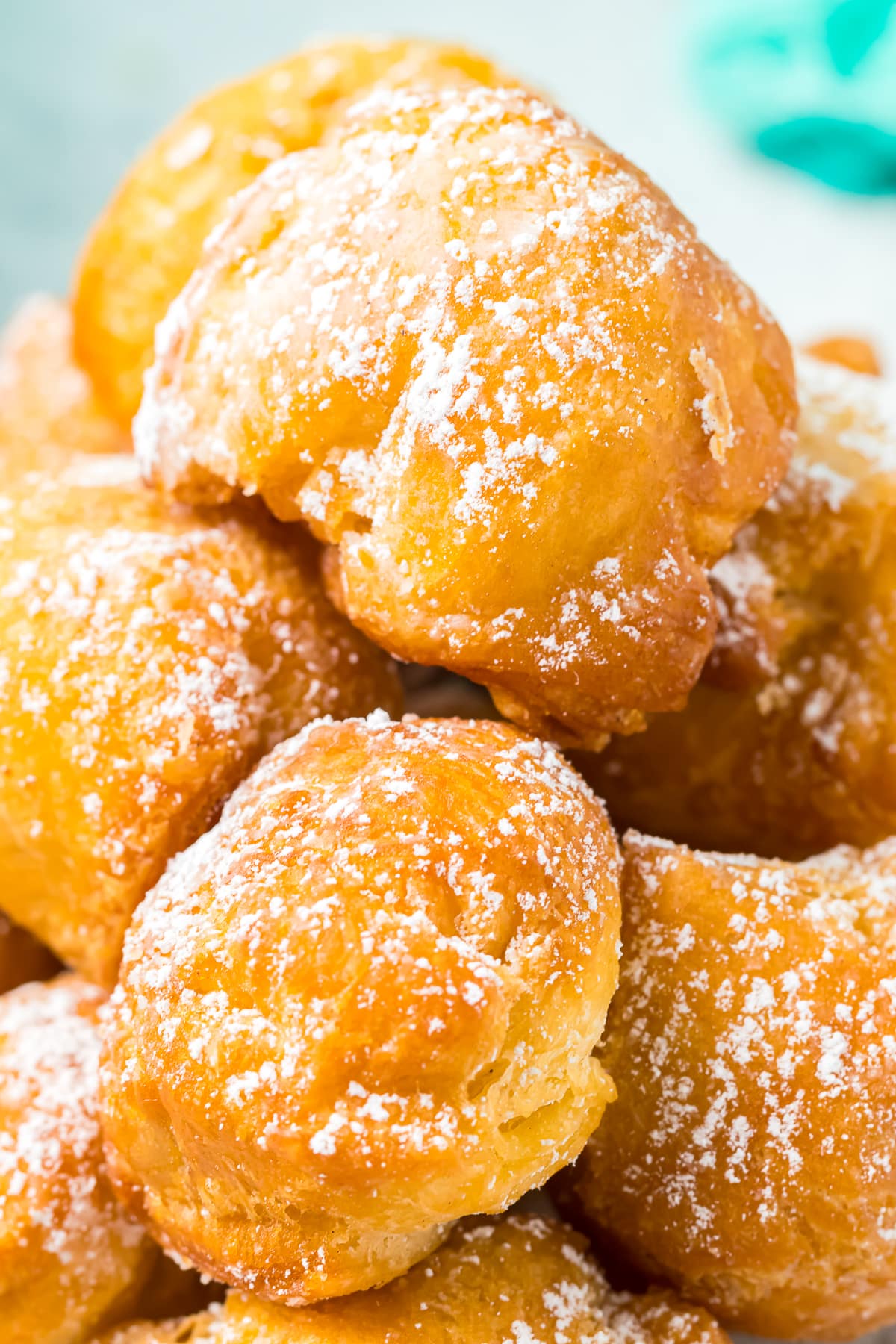 upclose image of donut holes with powdered sugar on top