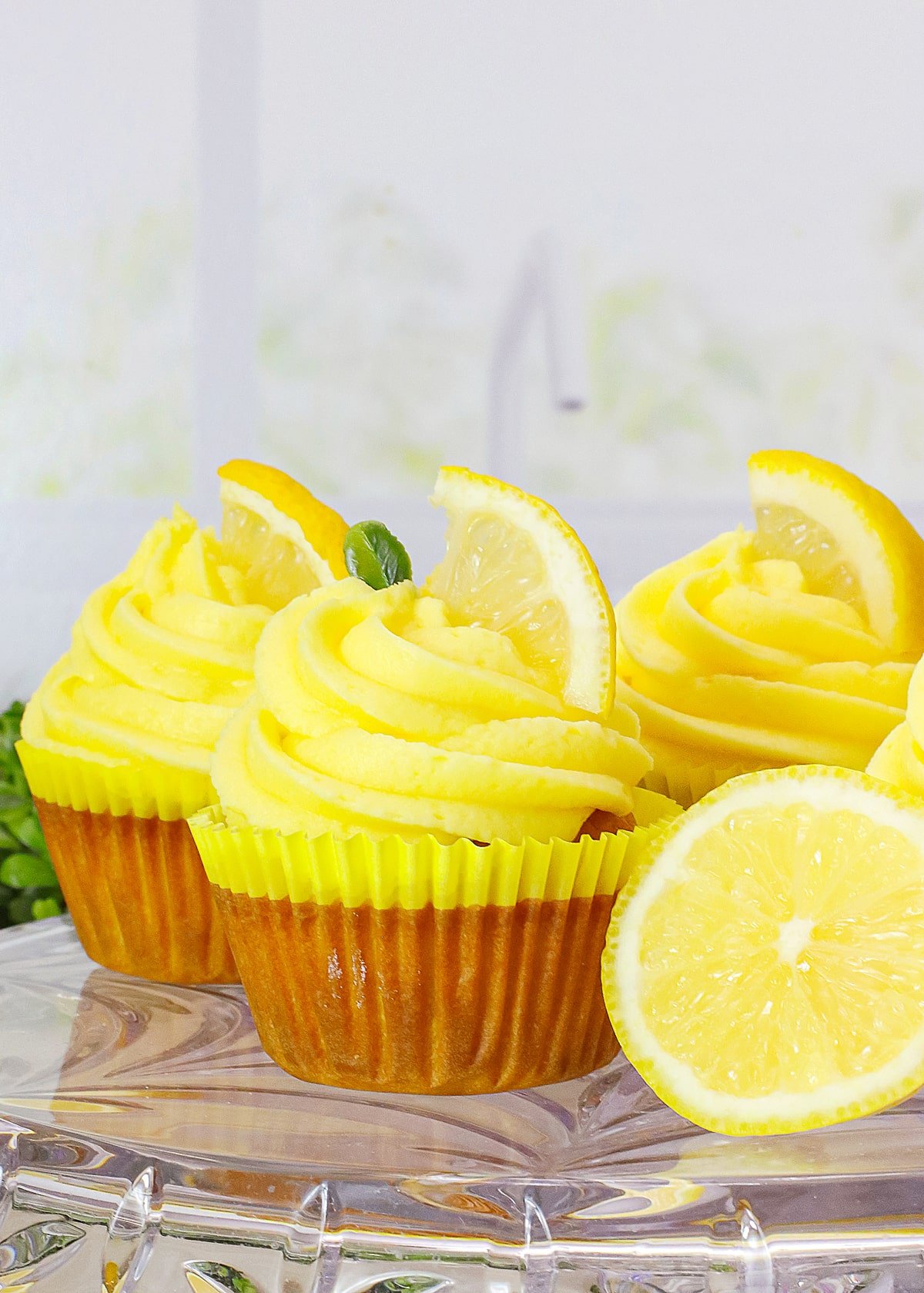lemon cupcakes on glass cake stand