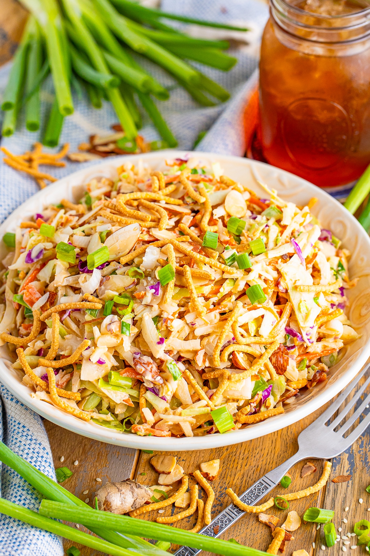 asian slaw recipe in serving bowl on a wooden table top