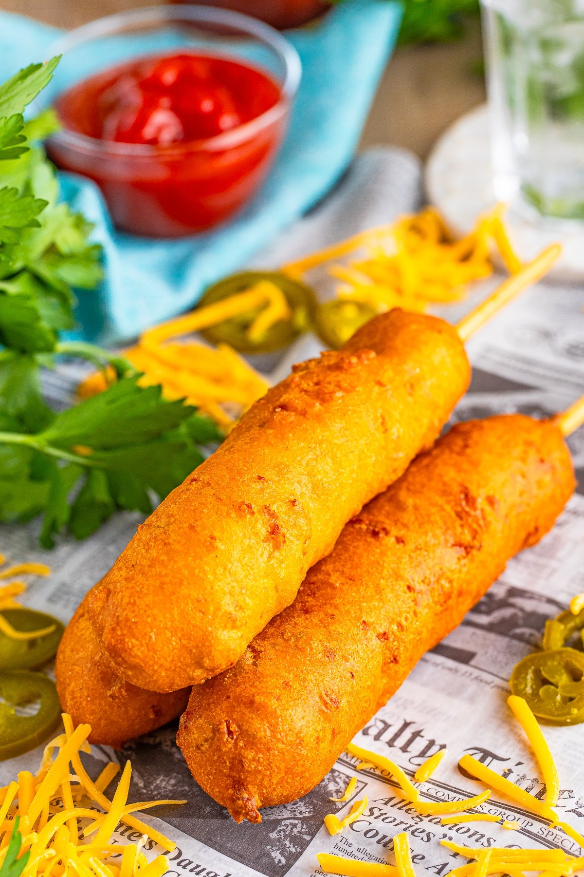 3 corn dogs recipe stacked on newspaper