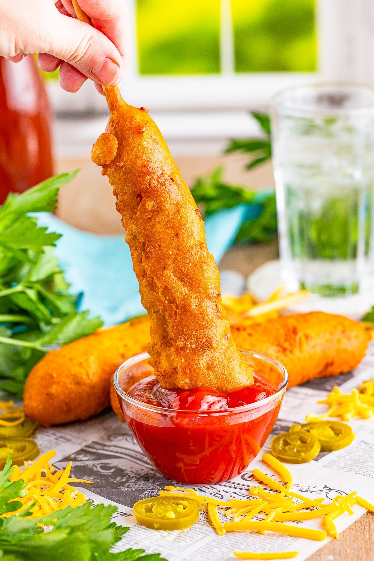 dipping corn dogs recipe into ketchup
