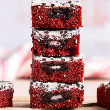 A stack of Red Velvet Brownies layered with Oreos and a cookies and cream top.
