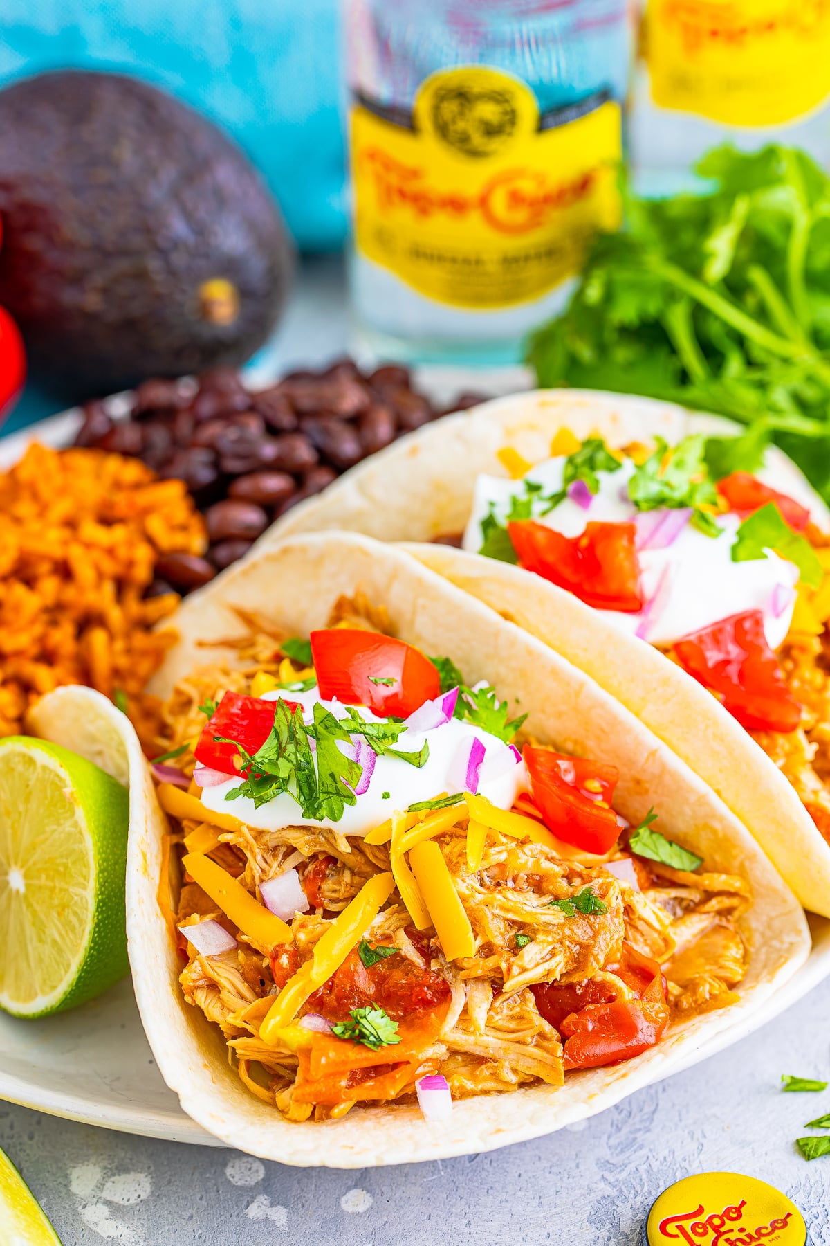 slow cooker mexican shredded chicken tacos on white plate