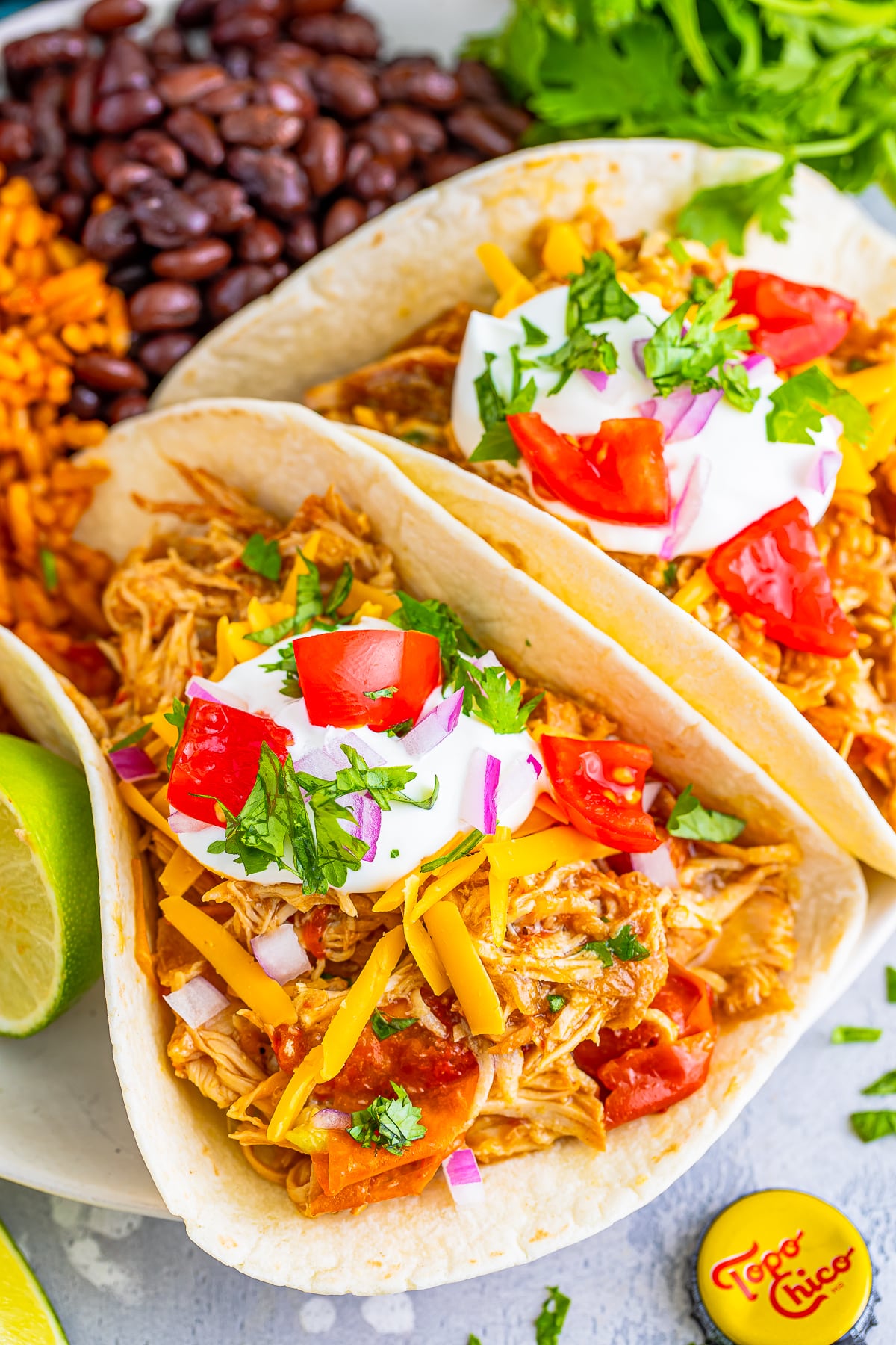overhead image slow cooker mexican shredded chicken tacos on serving plate