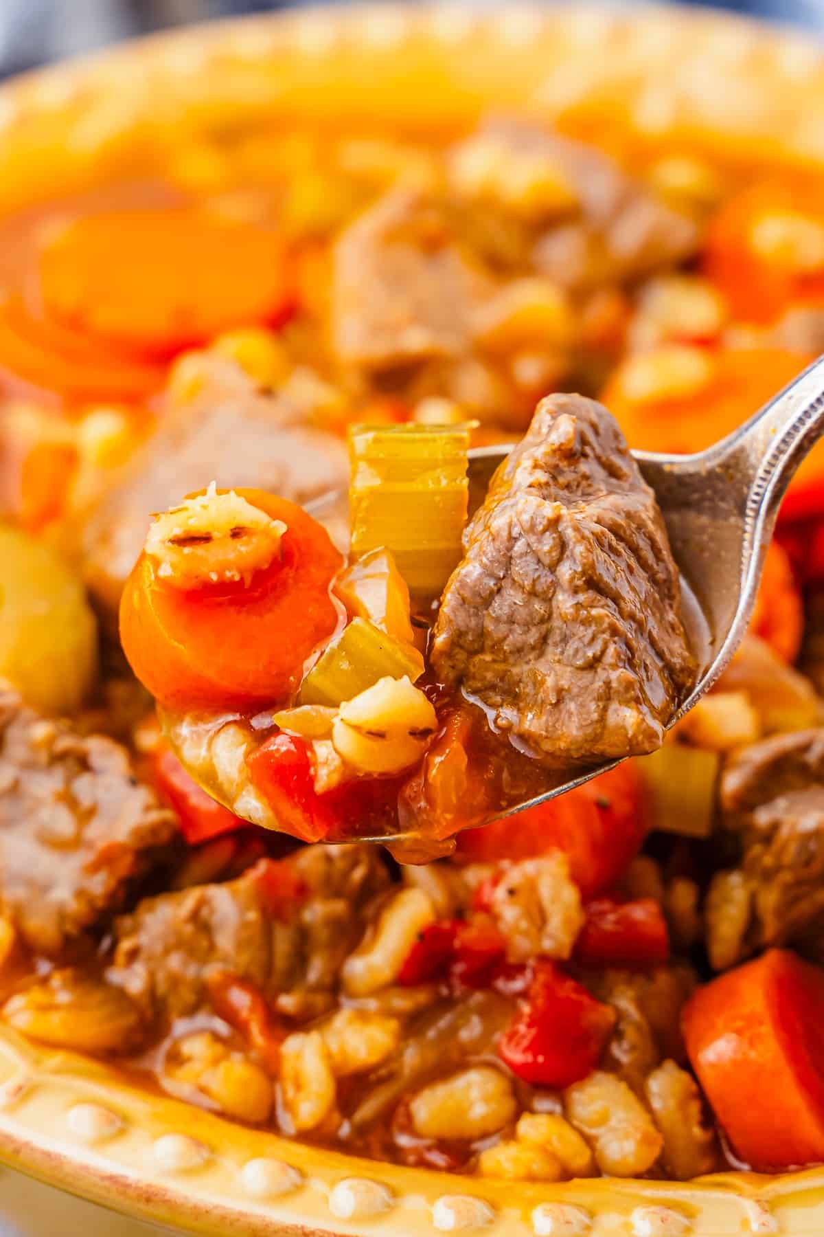up close image of a spoon grabbing a portion of Beef and Barley Soup Recipe