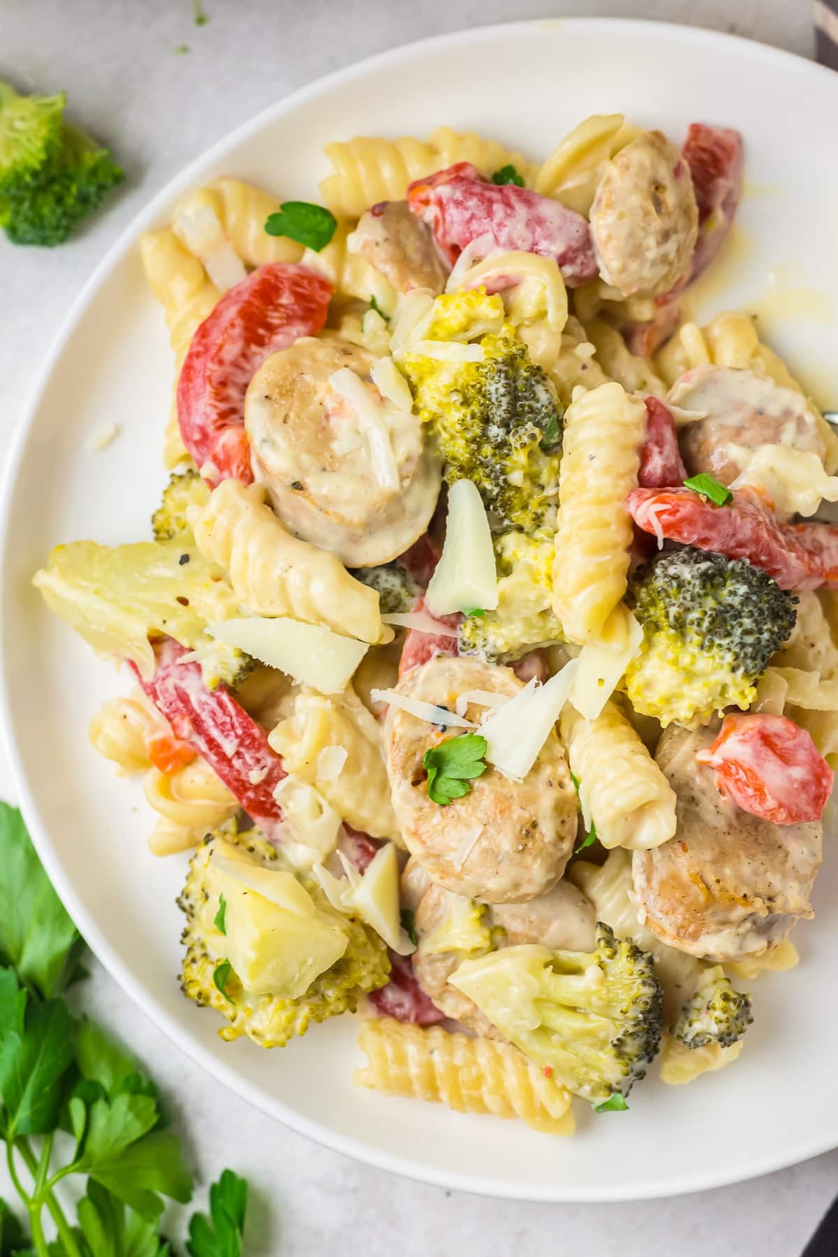overhead image chicken sausage pasta dish on a white serving plate