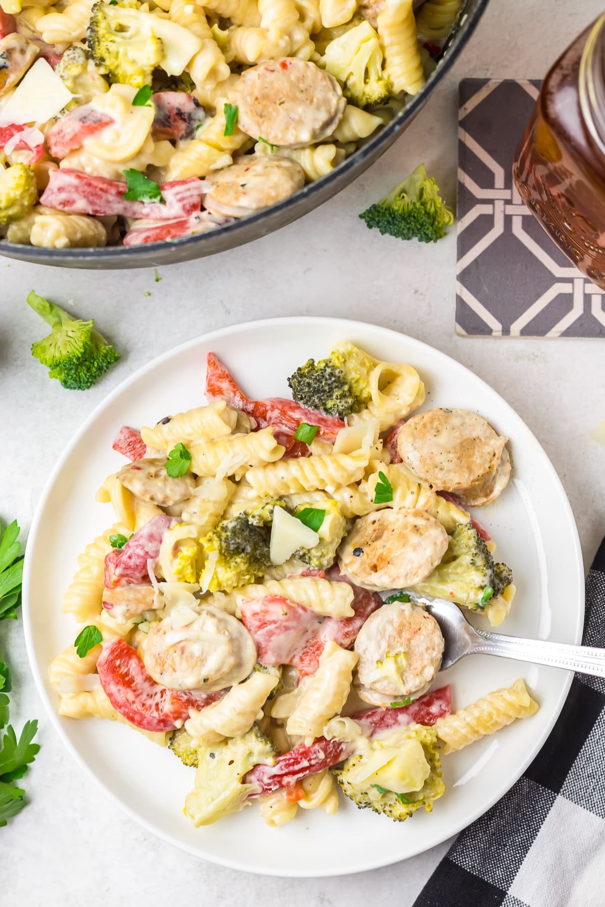 overhead image of chicken sausage pasta dish on a white plate