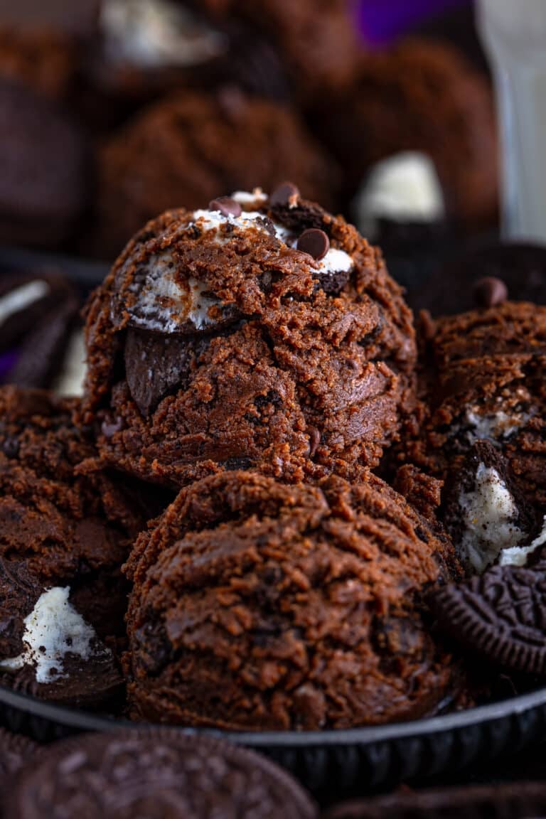 A bowl of edible chocolate cookie dough with Oreos and chocolate chips scooped into balls.