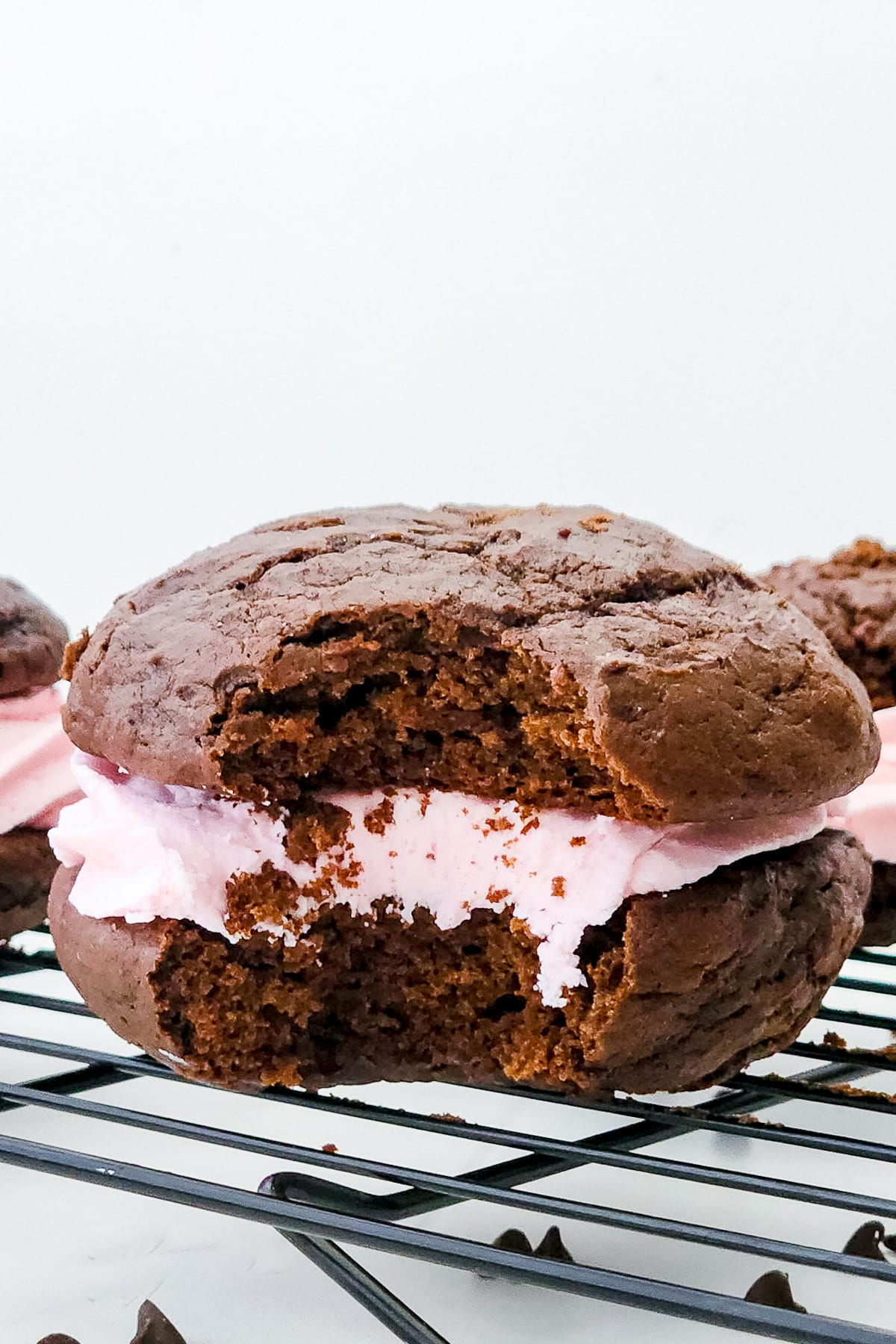Whoopie Pies Recipe with a bite taken out on a wire rack