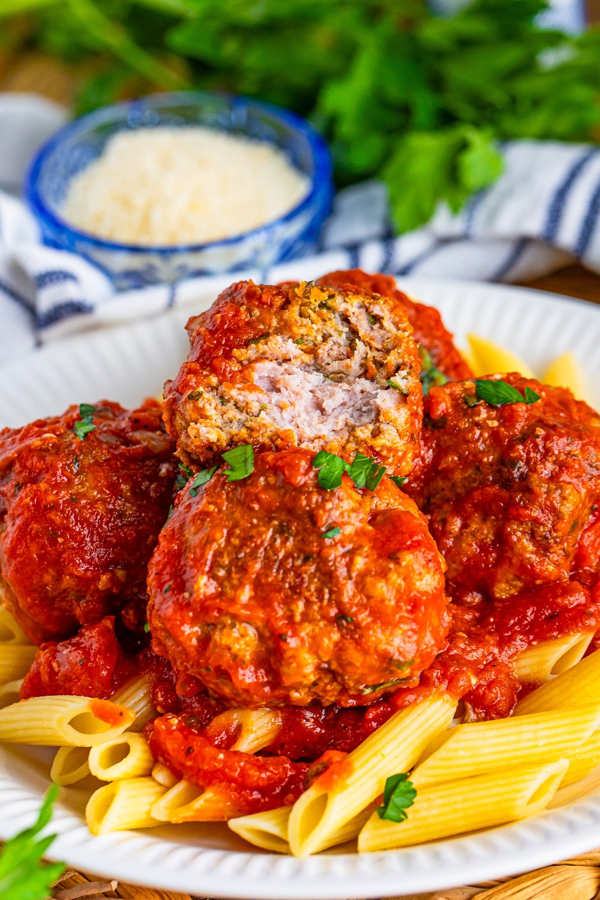 Italian Meatball Recipe with a bite taken out stacked on more meatballs