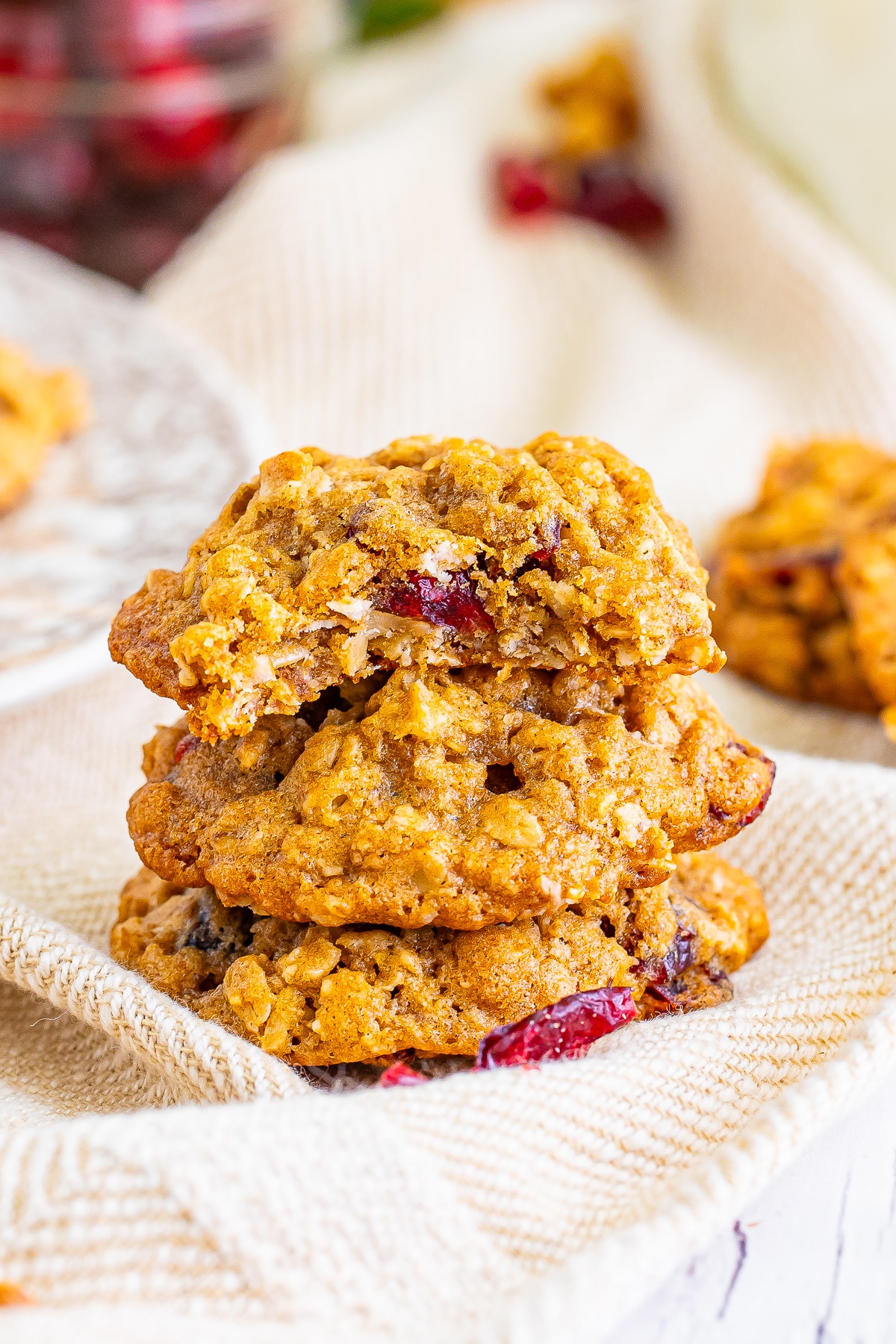 a stack of Cranberry Oatmeal Cookies with a bite taken out