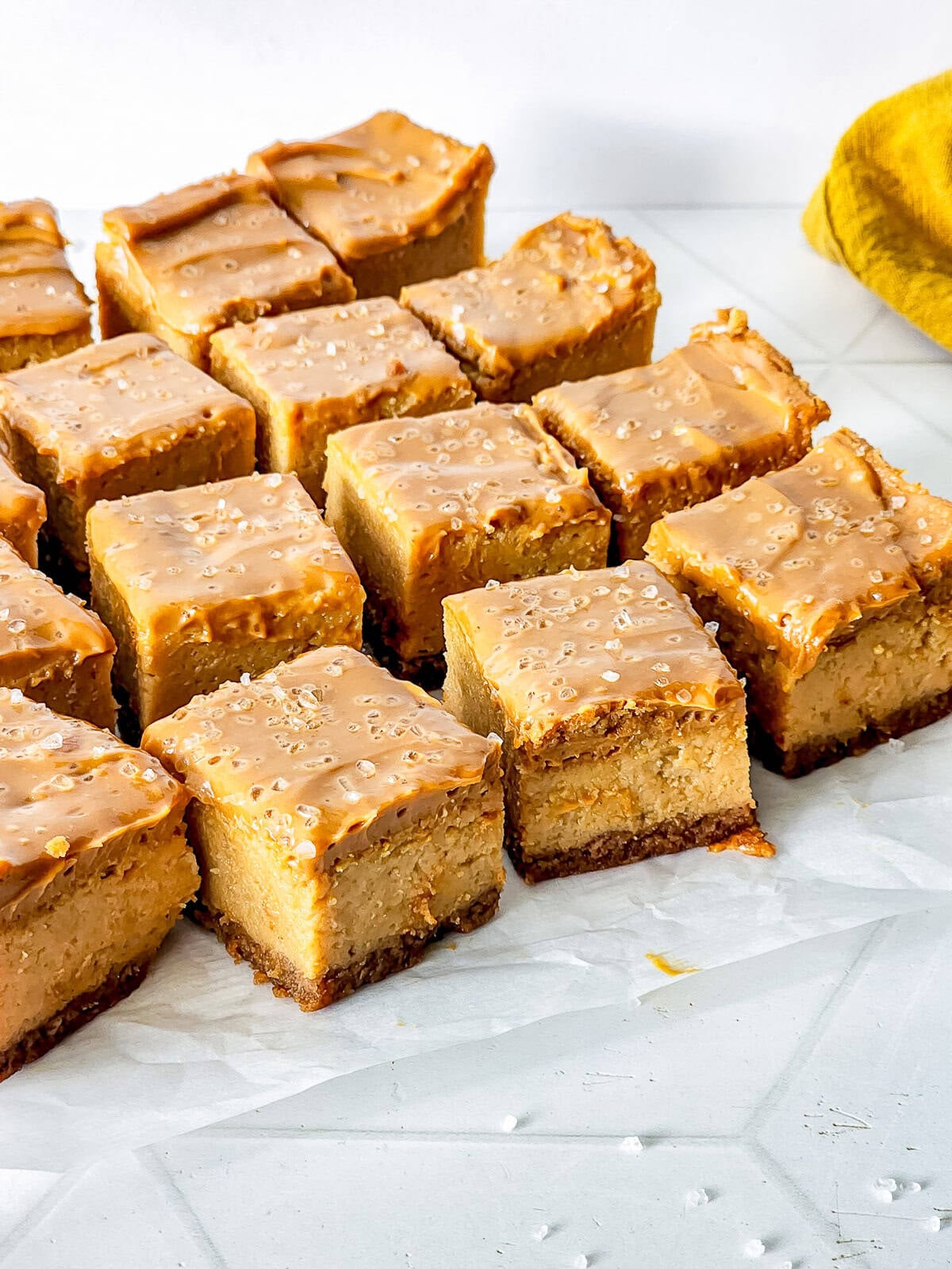 sliced up Dulce de Leche Cheesecake bites on parchment