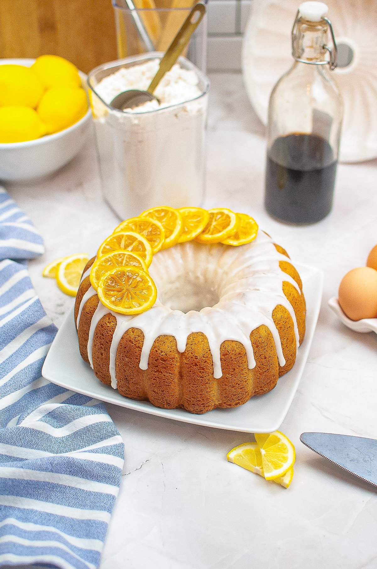 Lemon Bundt Cake on a serving platter on marble background