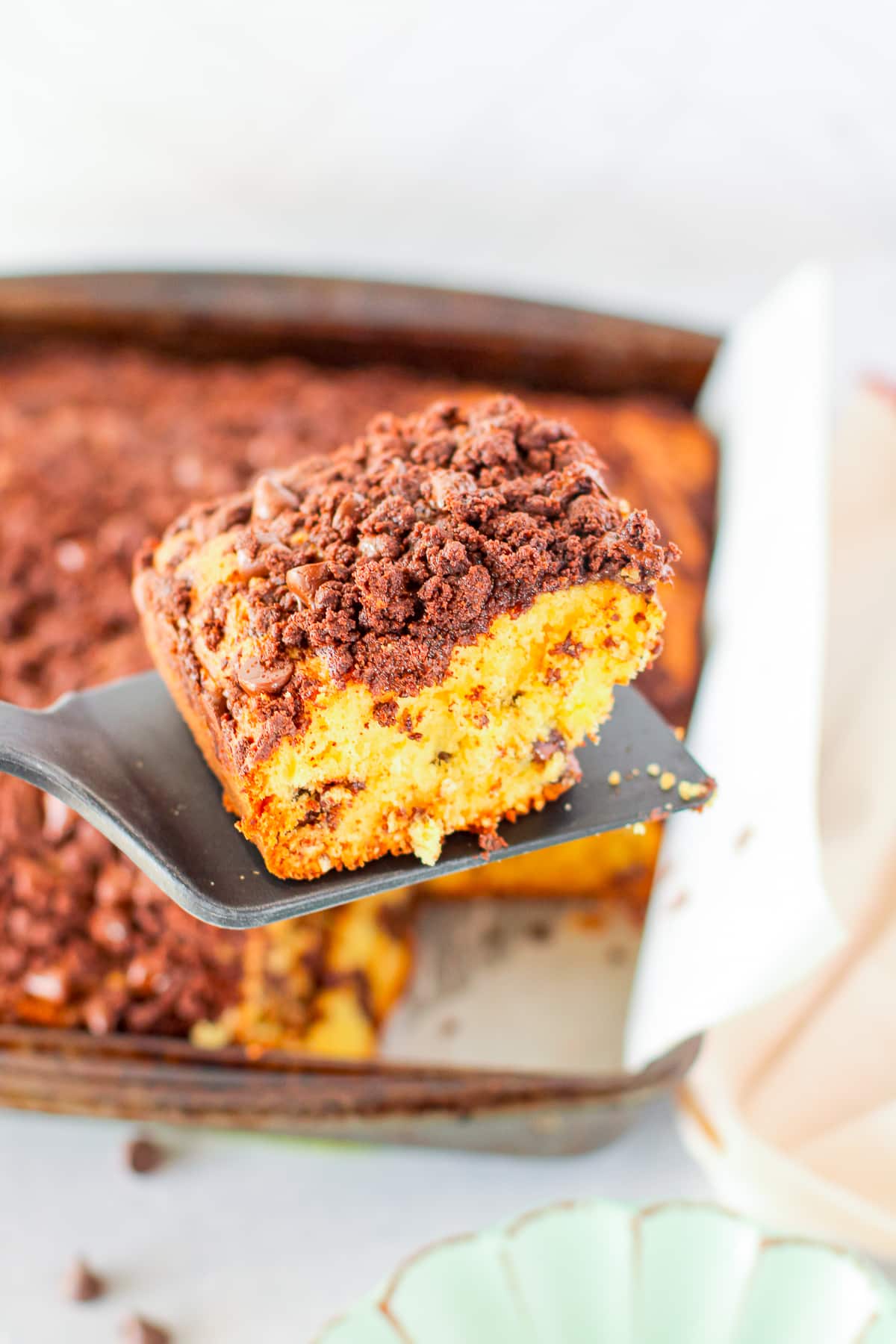 a spatula holding up a piece of coffee cake recipe in air