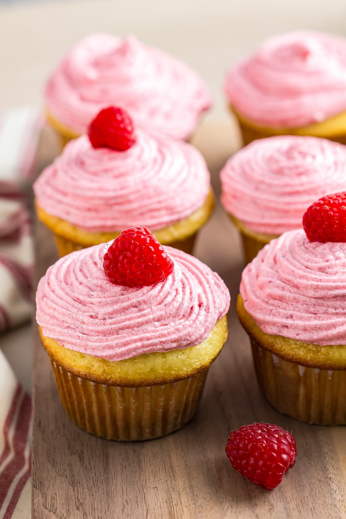 Raspberry Cupcakes on a wooden serving platter