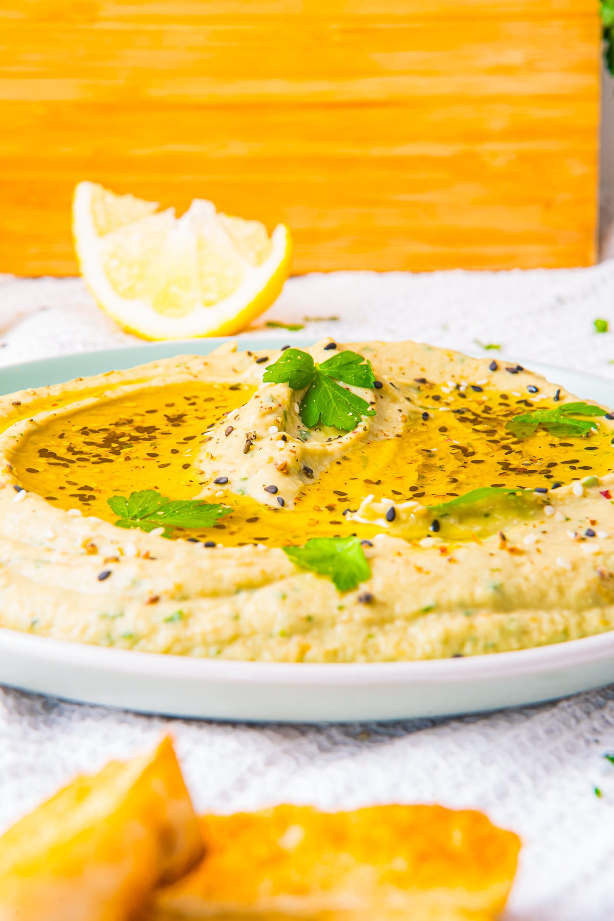 Baba Ganoush Recipe served with olive oil and garnishes on a green plate