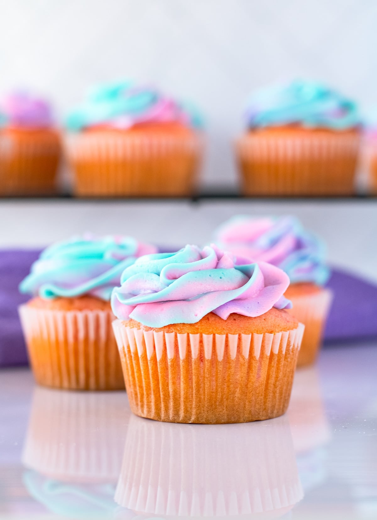 Cherry Cupcakes lined up on a white table top