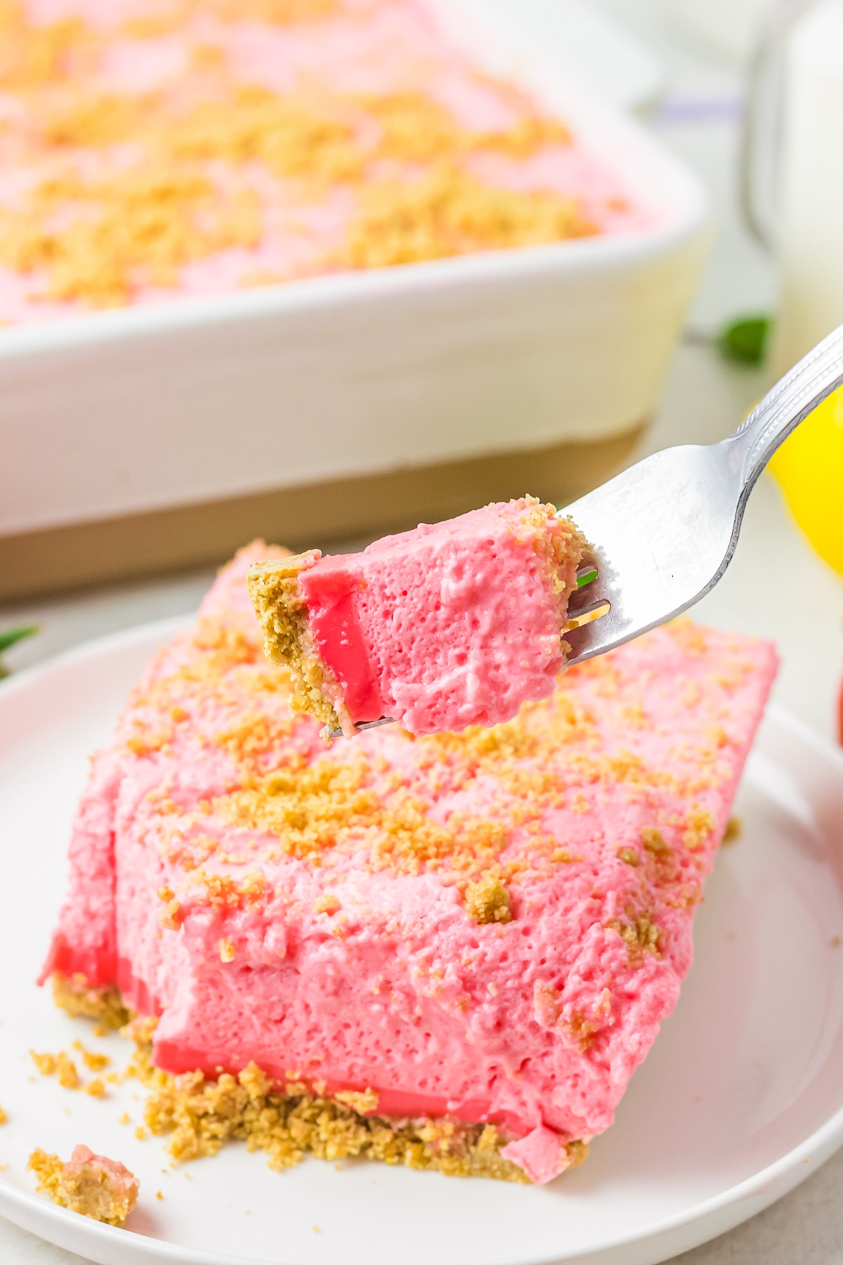 a fork holding up a bite of Woolworth Cake in air