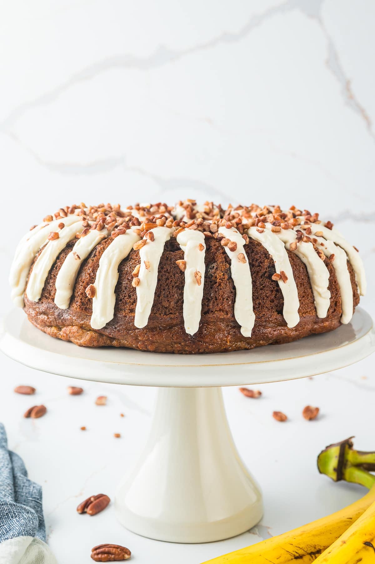 Banana Bundt Cake on a white cake stand