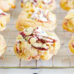 Blueberry pop tart sugar cookies on a wire rack topped with crushed Pop-Tarts and sprinkles.