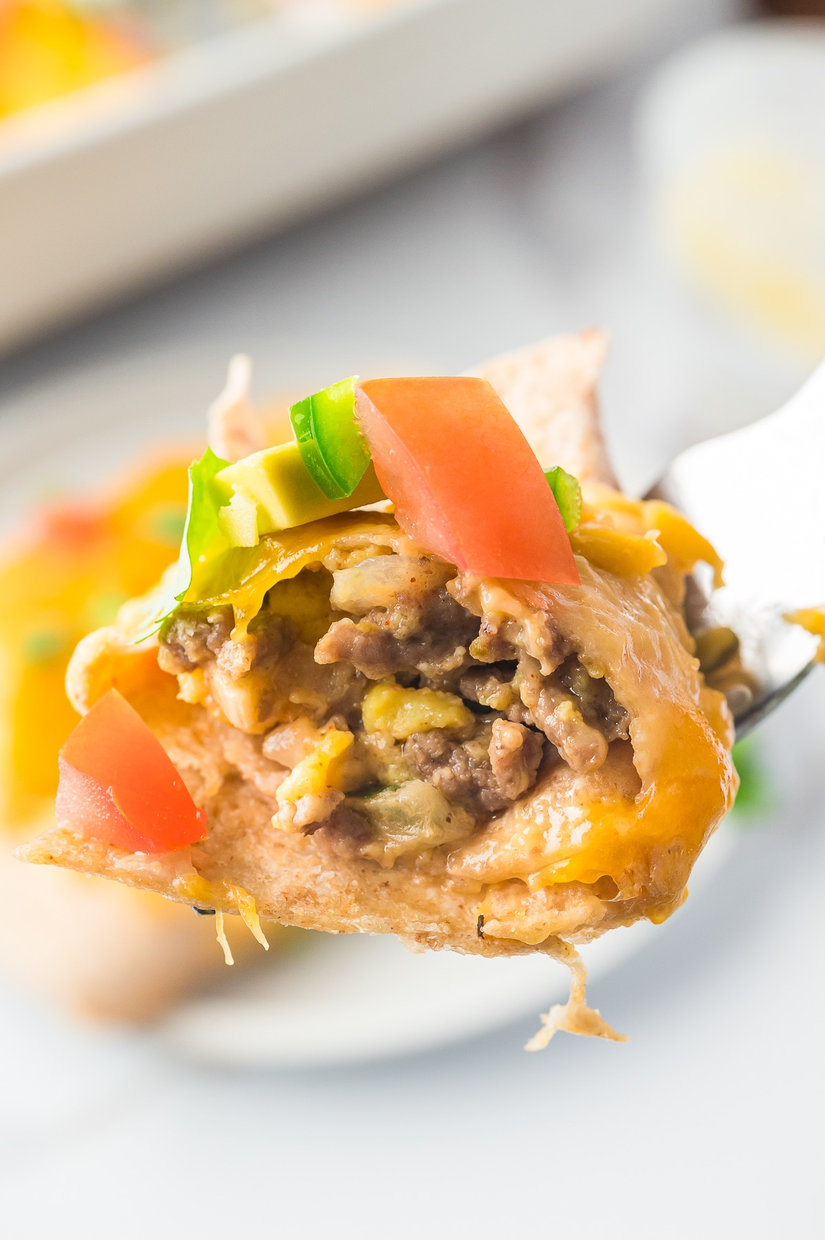 a bite of Breakfast Enchiladas on a fork in air