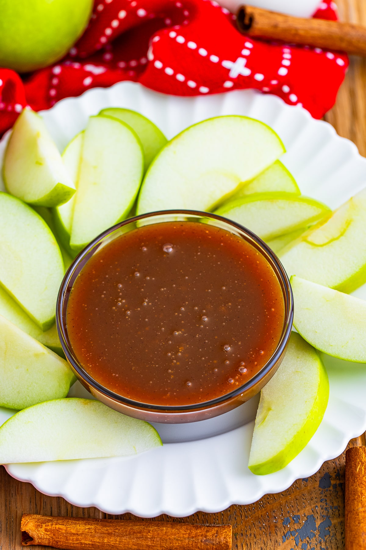 overhead image of Easy Caramel Sauce in a glass bowl with apples
