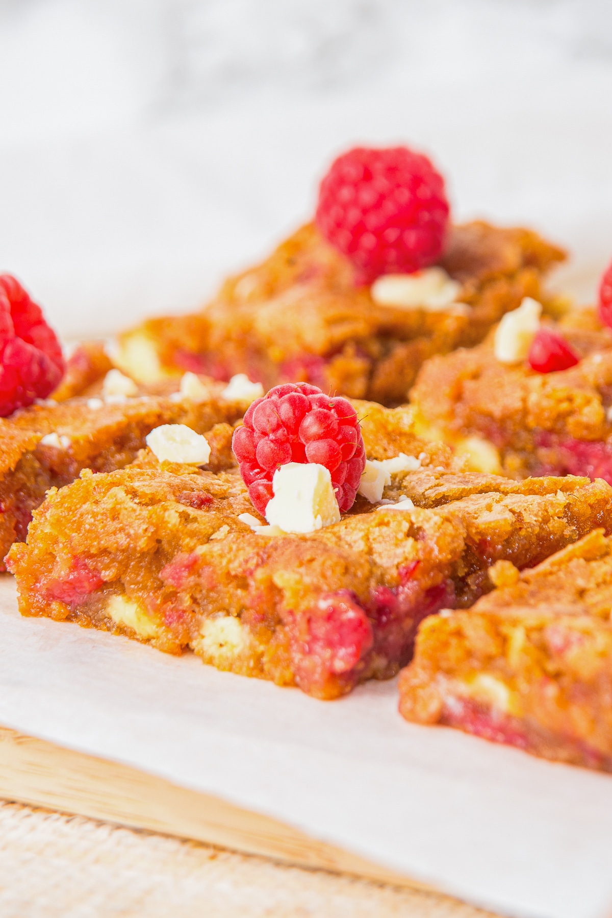 Raspberry White Chocolate Brownies on parchment paper