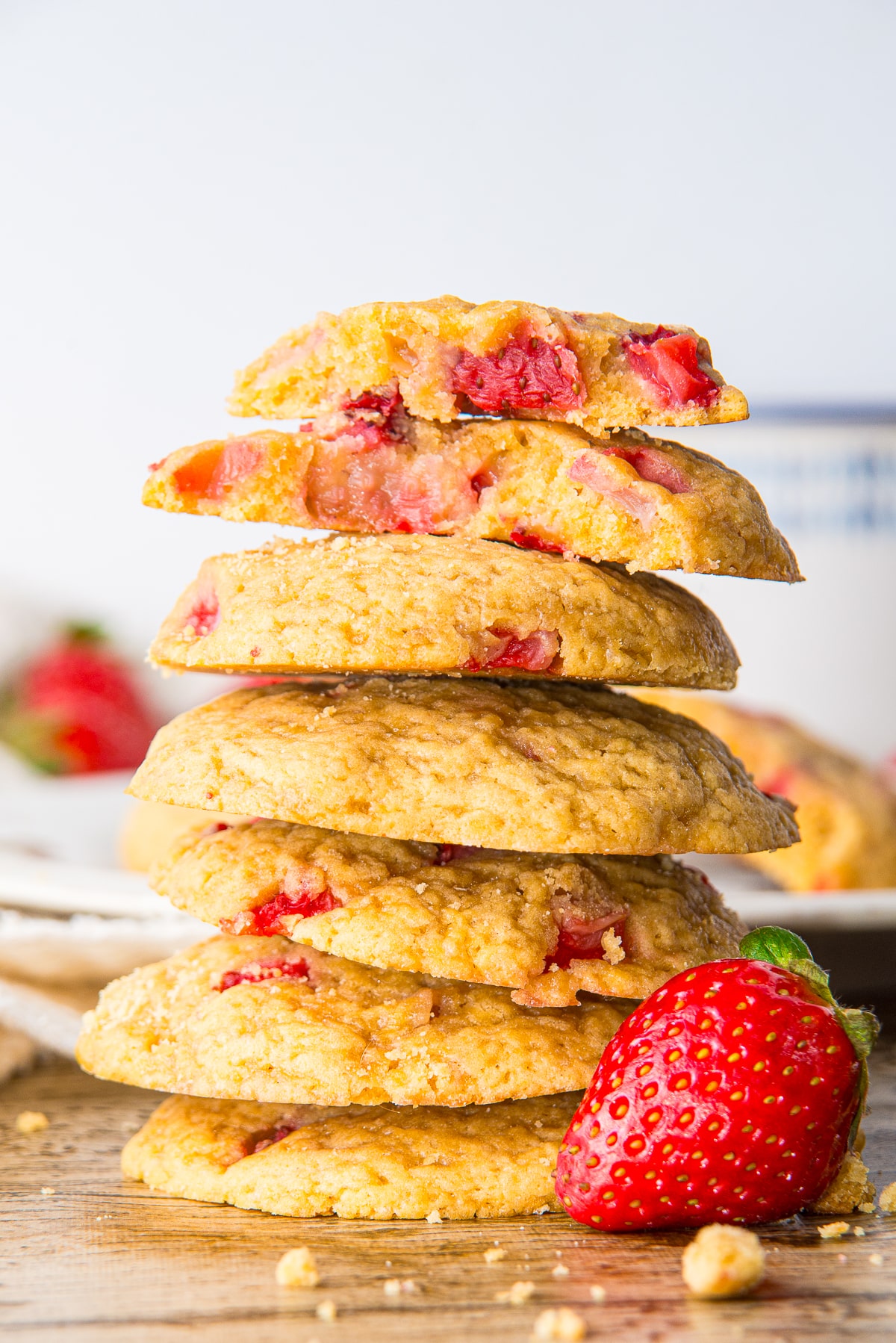 a stack of Strawberry Cookies with one of them broken in half on top 