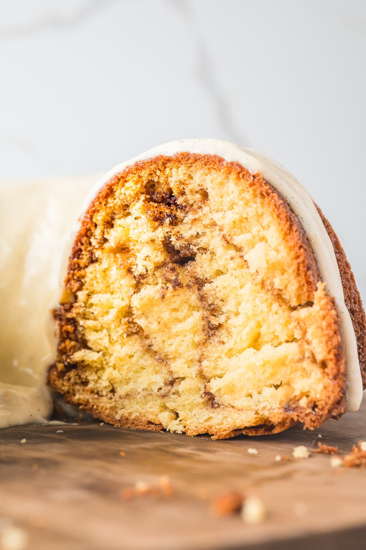 cut coffee cake bundt cake on wooden stand to show the interior of the cake