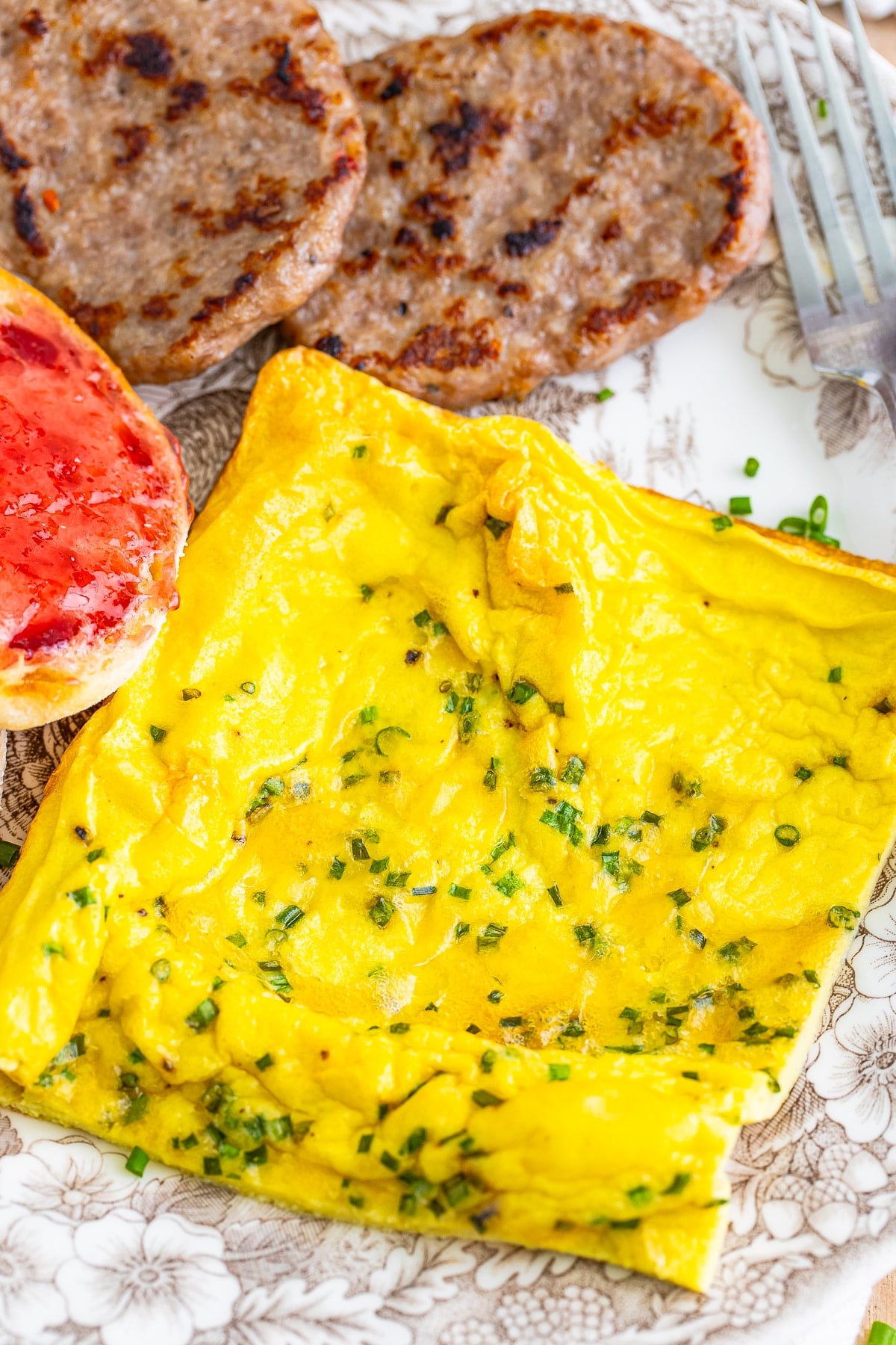 up close image a piece of sheet pan omelet on serving plate with sides