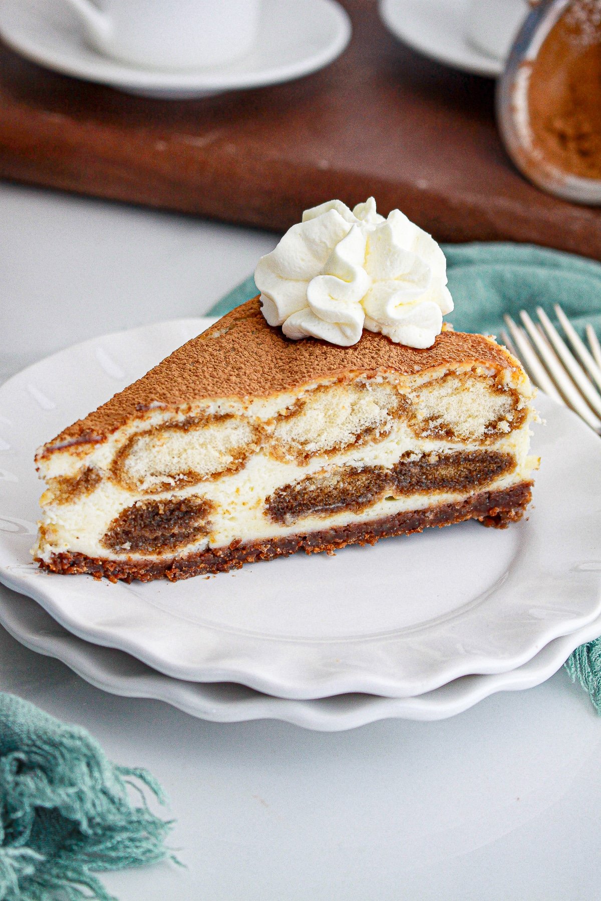 a slice of Tiramisu Cheesecake on a white plate