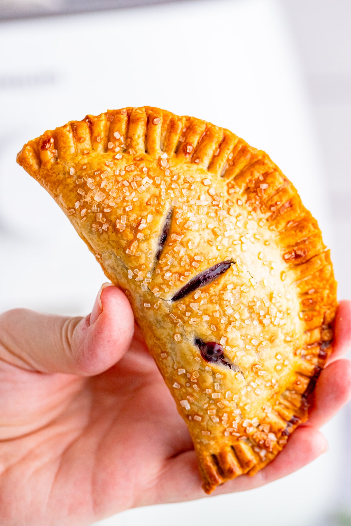a hand holding up Hand Pies in air