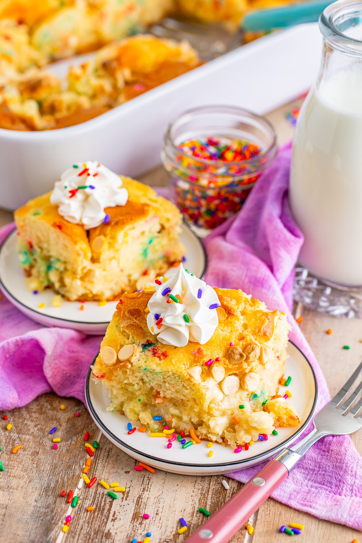 two slices of Earthquake Cake recipe on serving plate with whipped cream