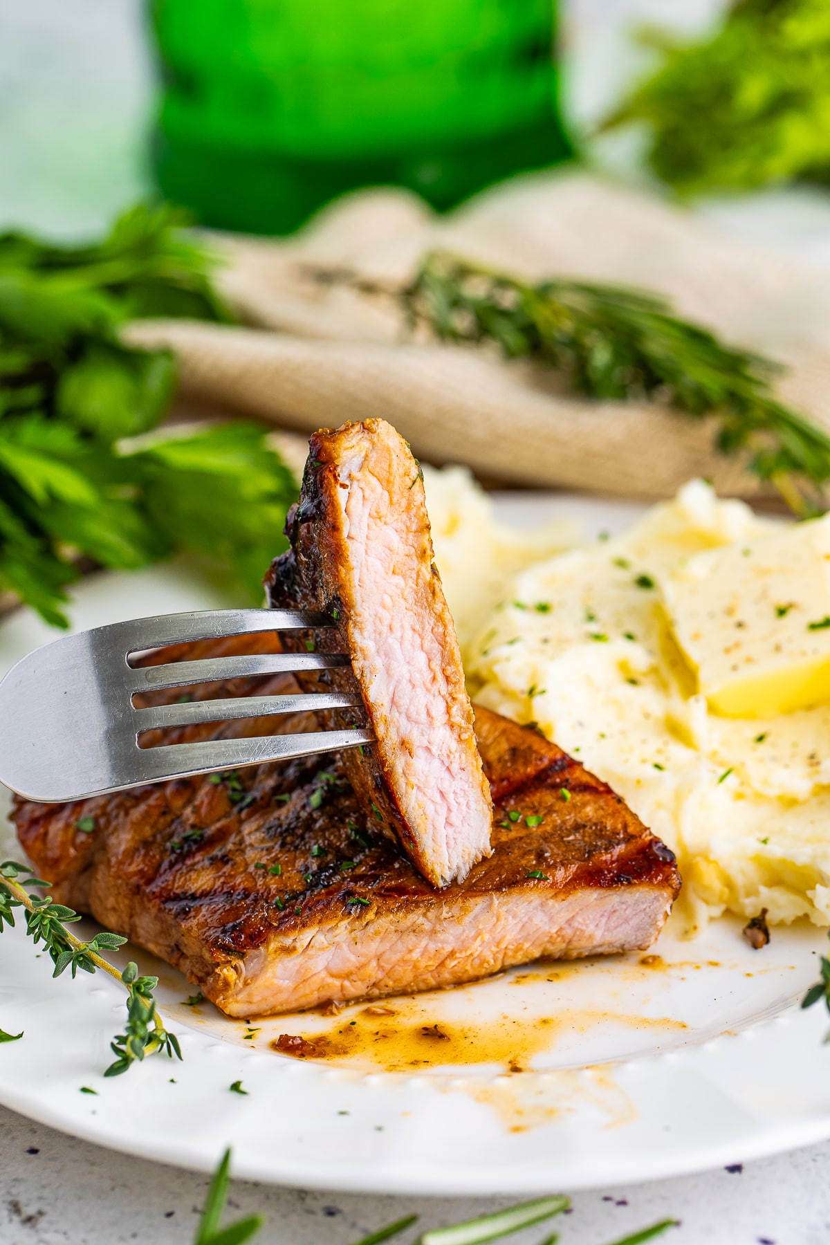 Grilled Pork Chops sliced in half to show interior on white plate