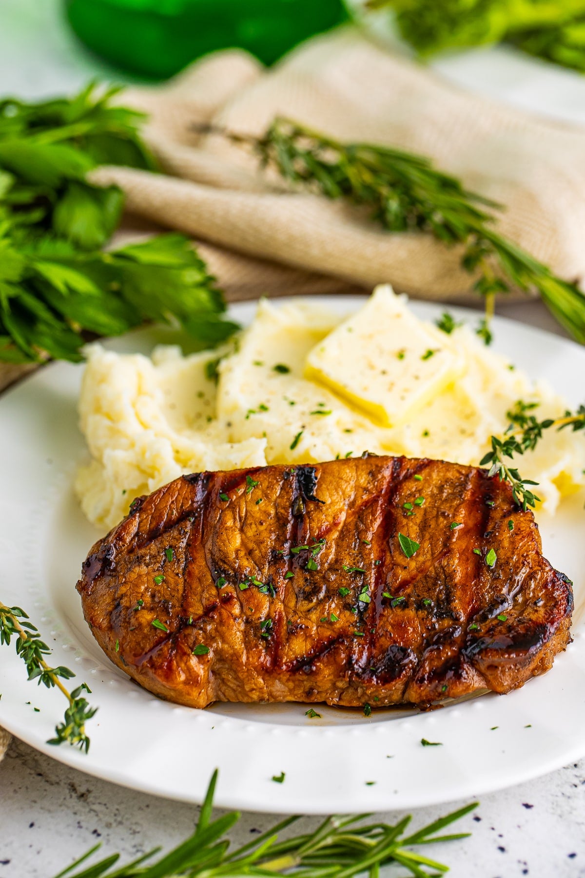 Grilled Pork Chops on a white plate with potatoes