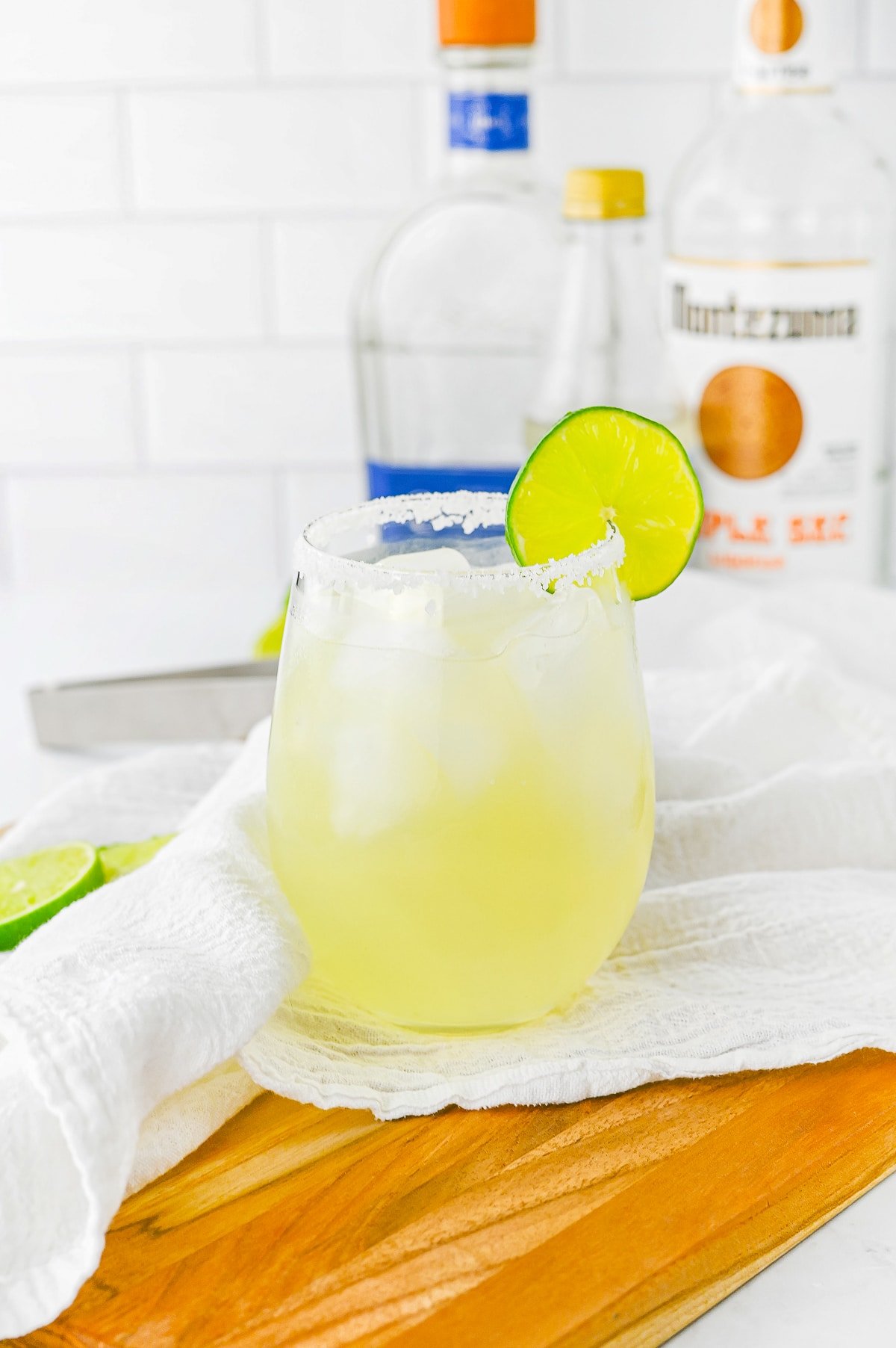 Lime Margarita in a glass on wooden board