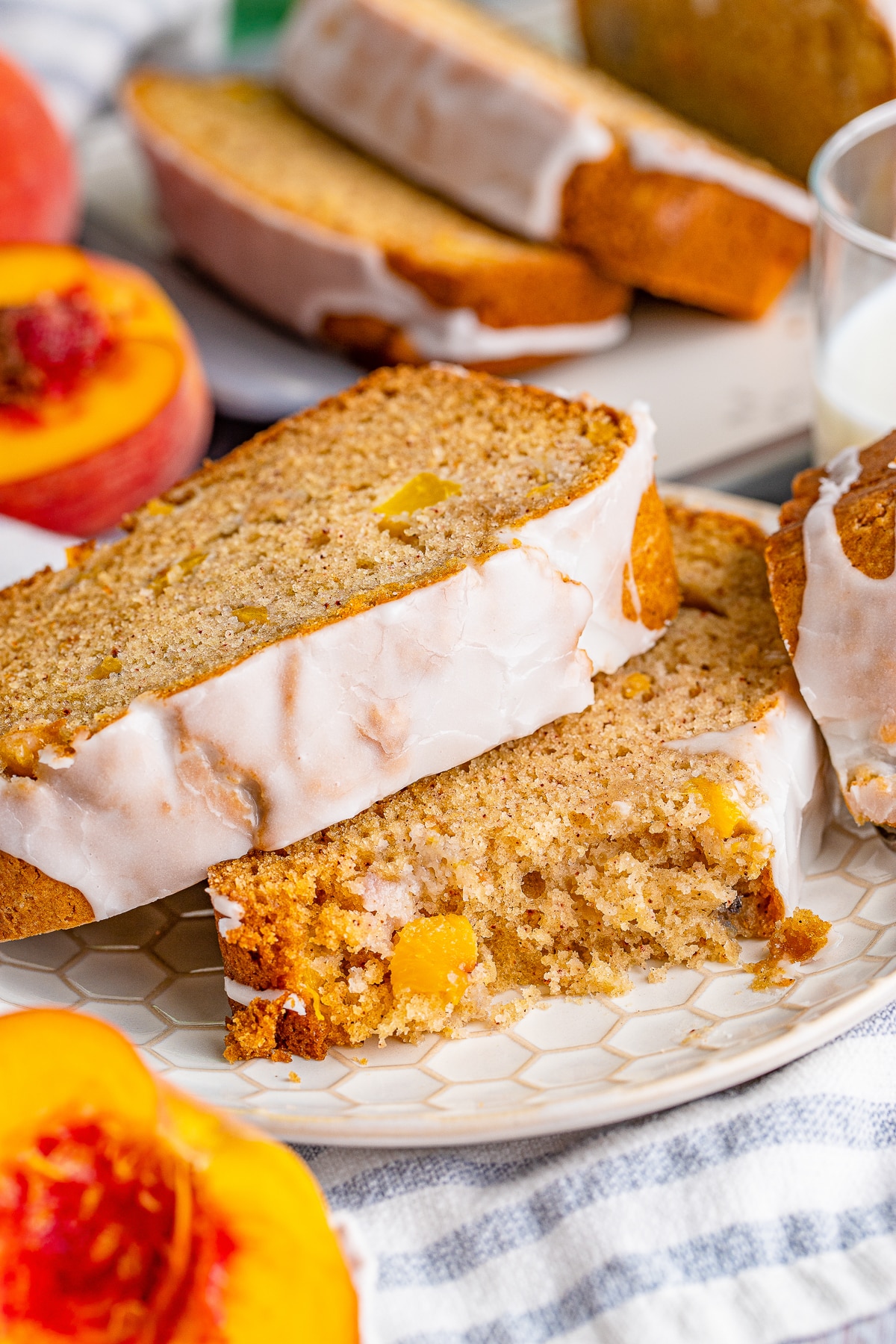 a piece of peach bread with a bites taken out on a tan plate